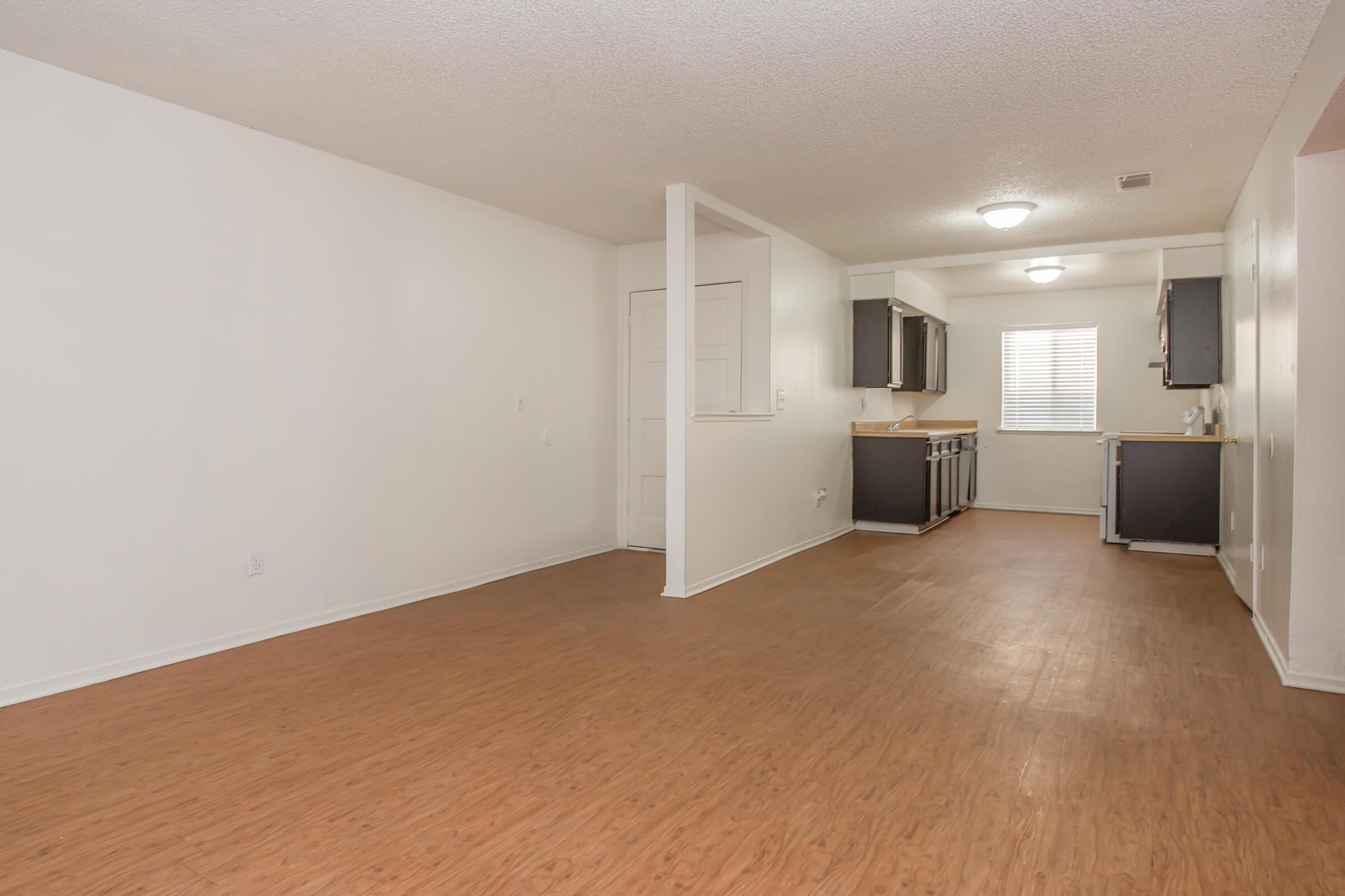 a large empty room with a wood floor