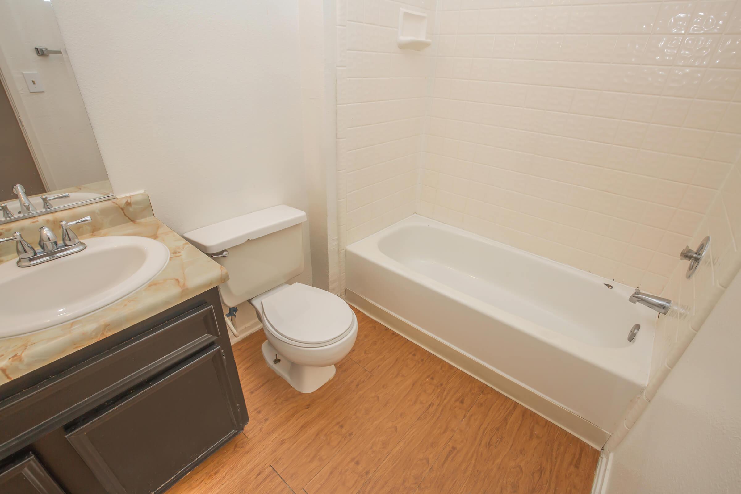 a white tub sitting next to a sink