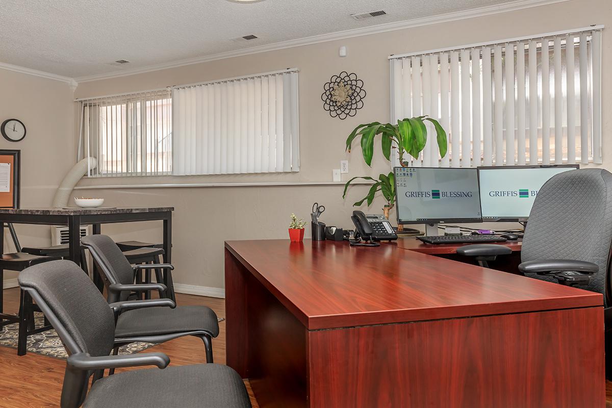 an office with a desk and chair in a room