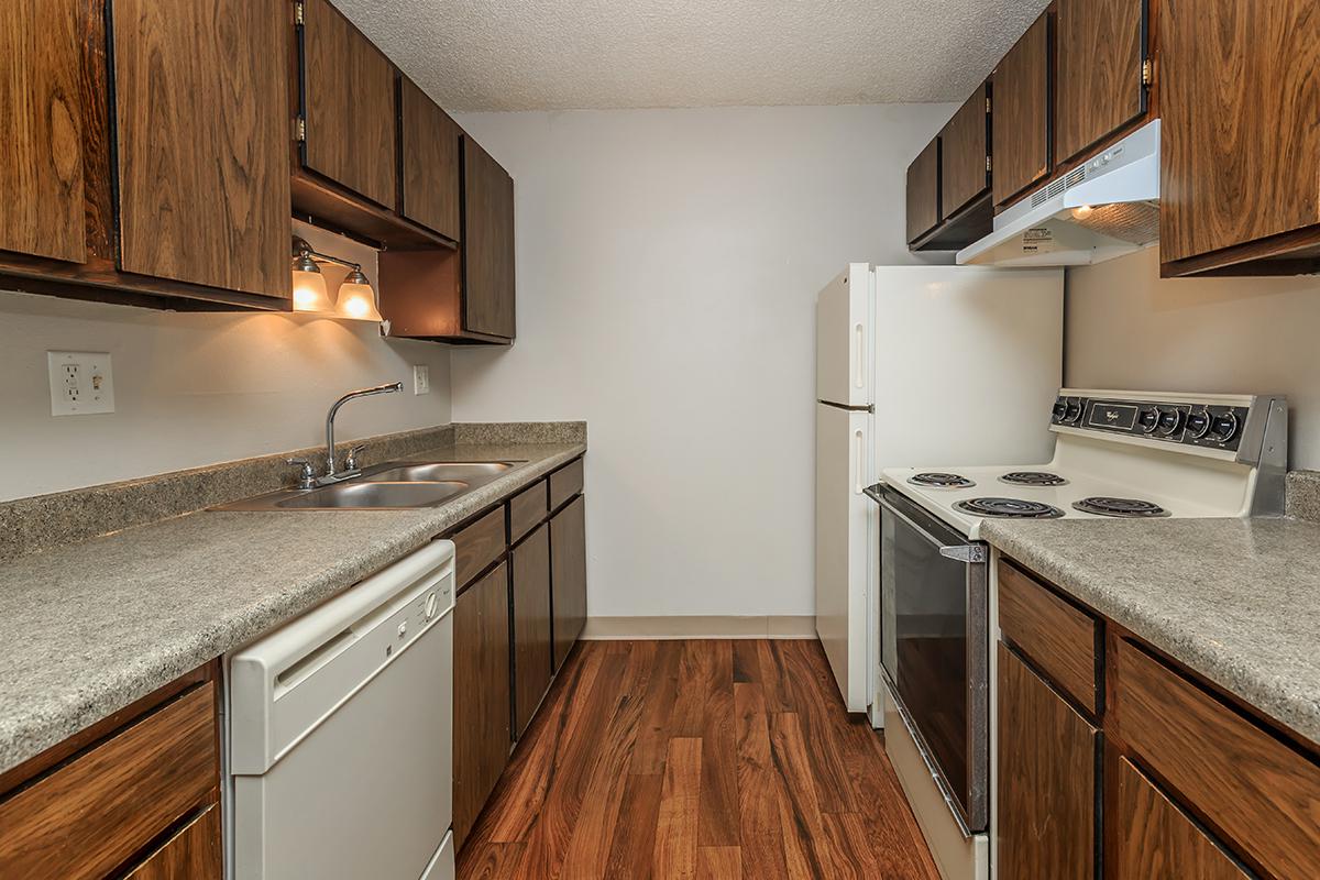 a kitchen with stainless steel appliances and wooden cabinets