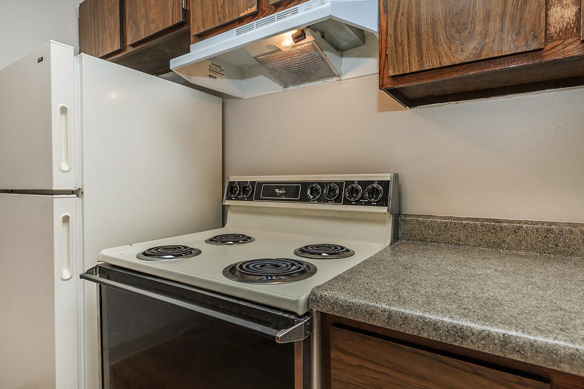 a white stove top oven sitting inside of a kitchen