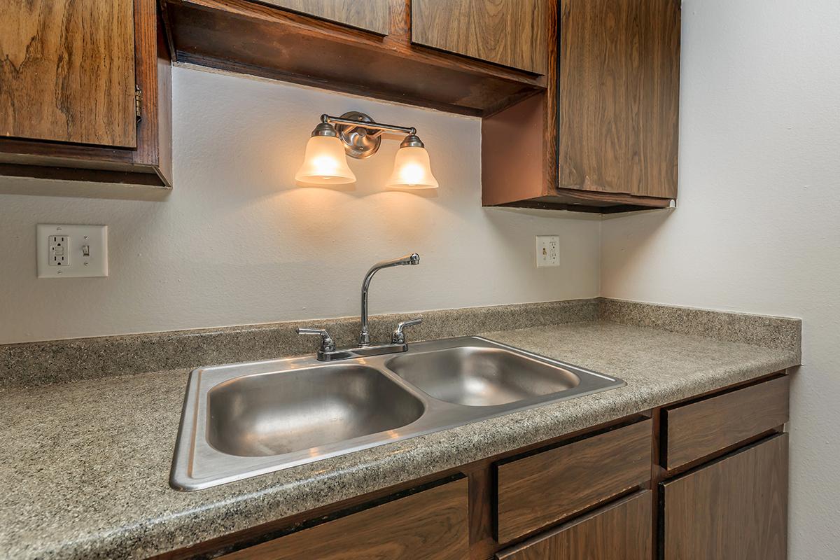 a kitchen with a sink and a mirror