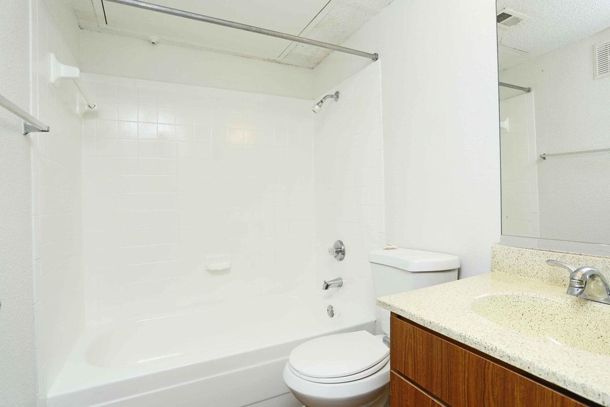 a white sink sitting next to a shower