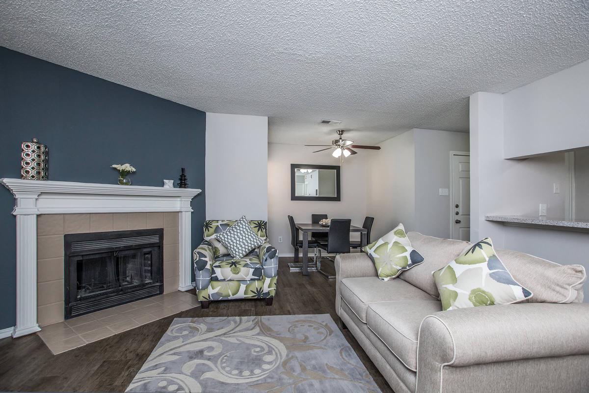 a living room filled with furniture and a flat screen tv