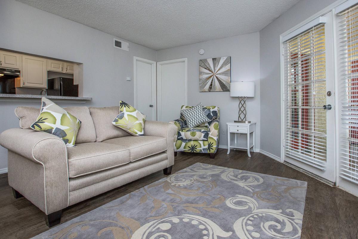 a living room filled with furniture and a rug