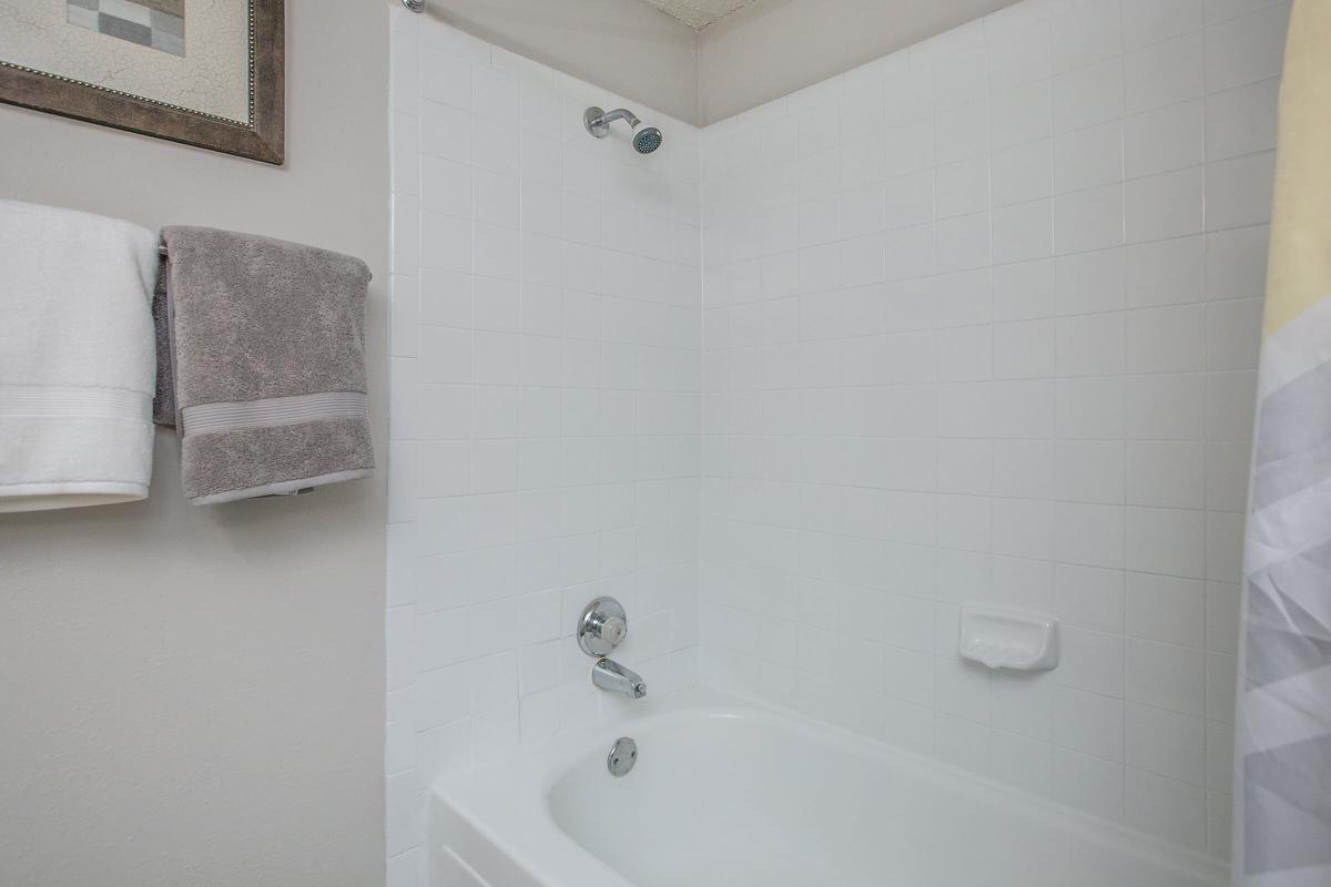 a white tub sitting next to a sink