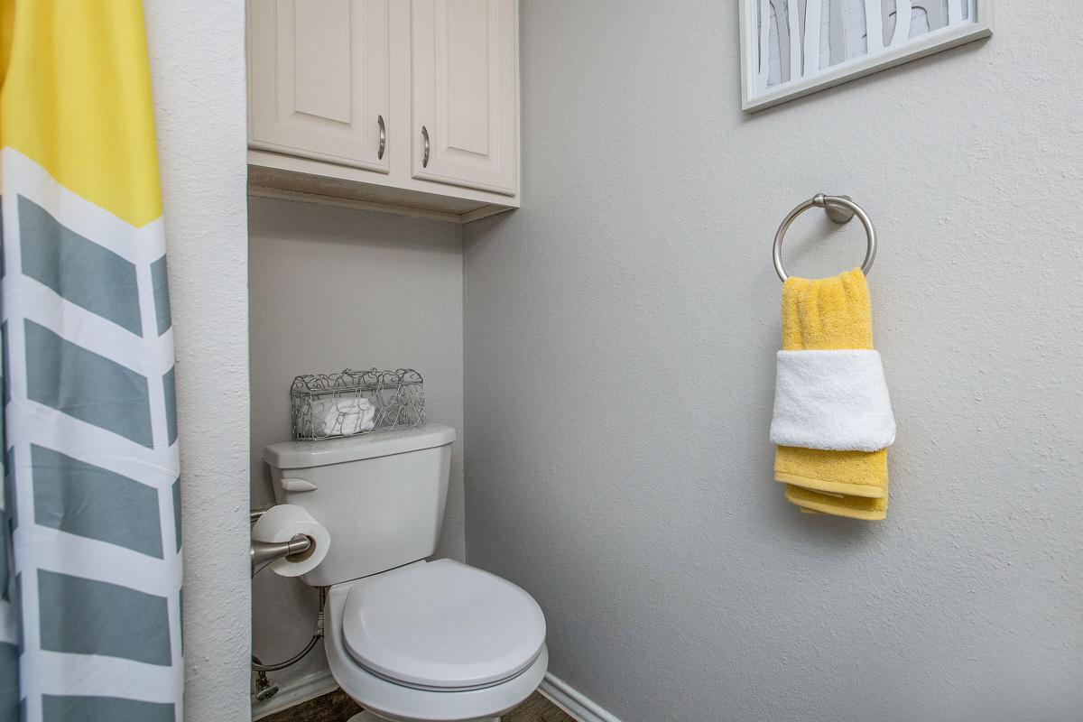 a white sink sitting under a mirror
