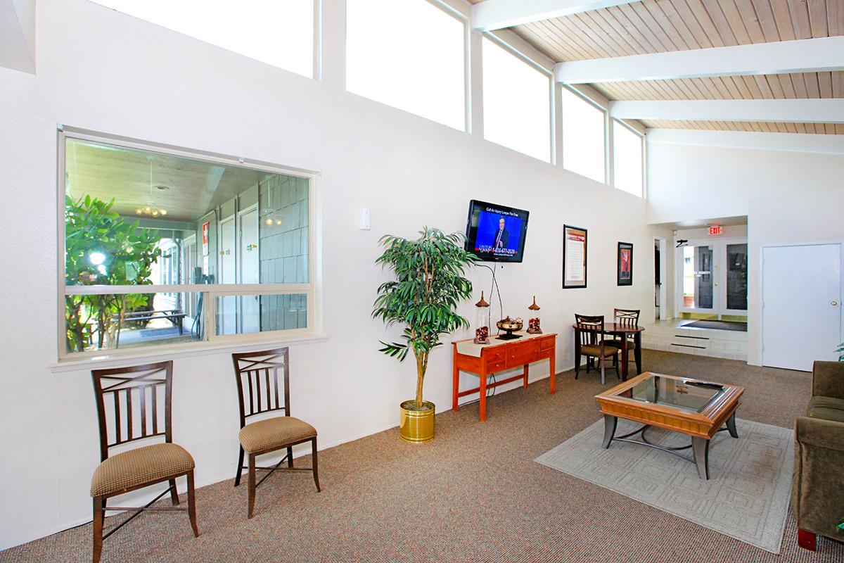a living room filled with furniture and a table