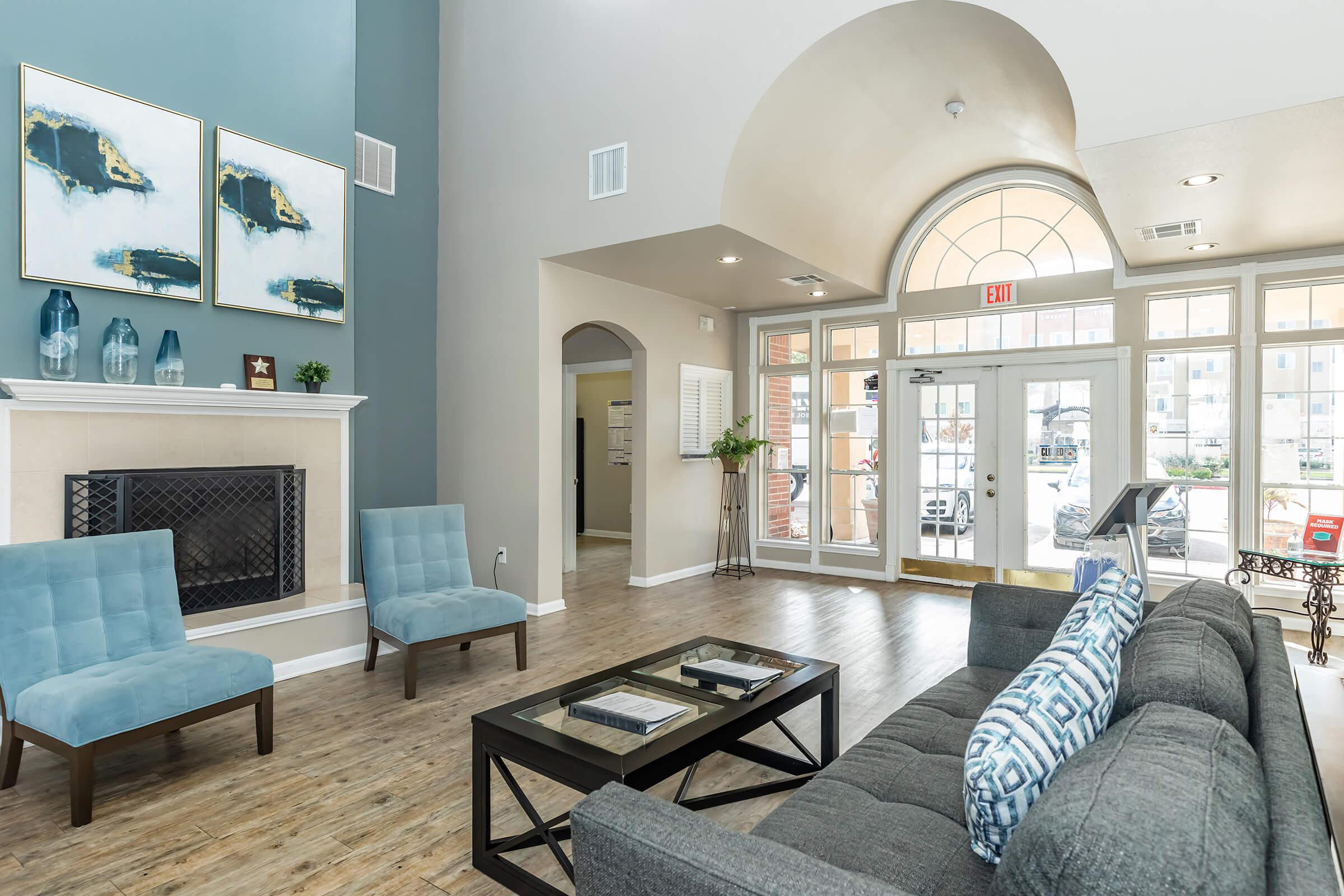 a living room filled with furniture and a large window