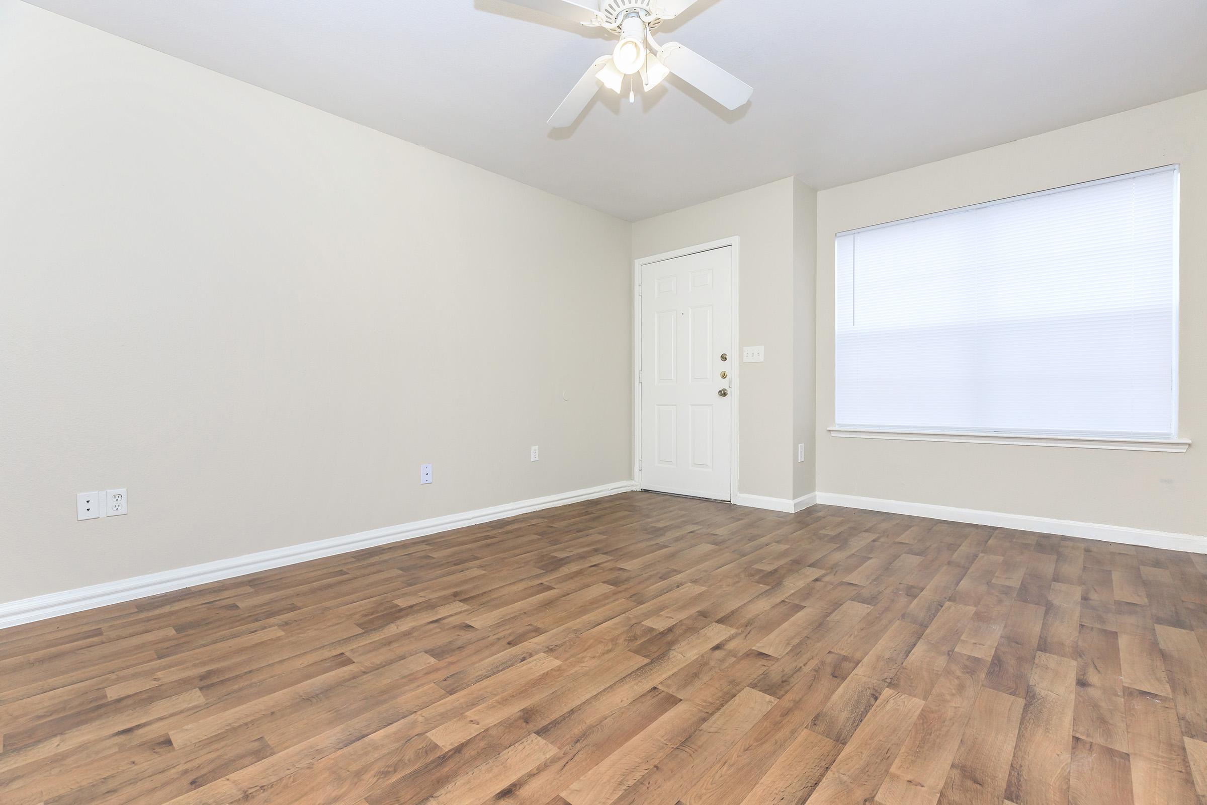 a large empty room with a wooden floor