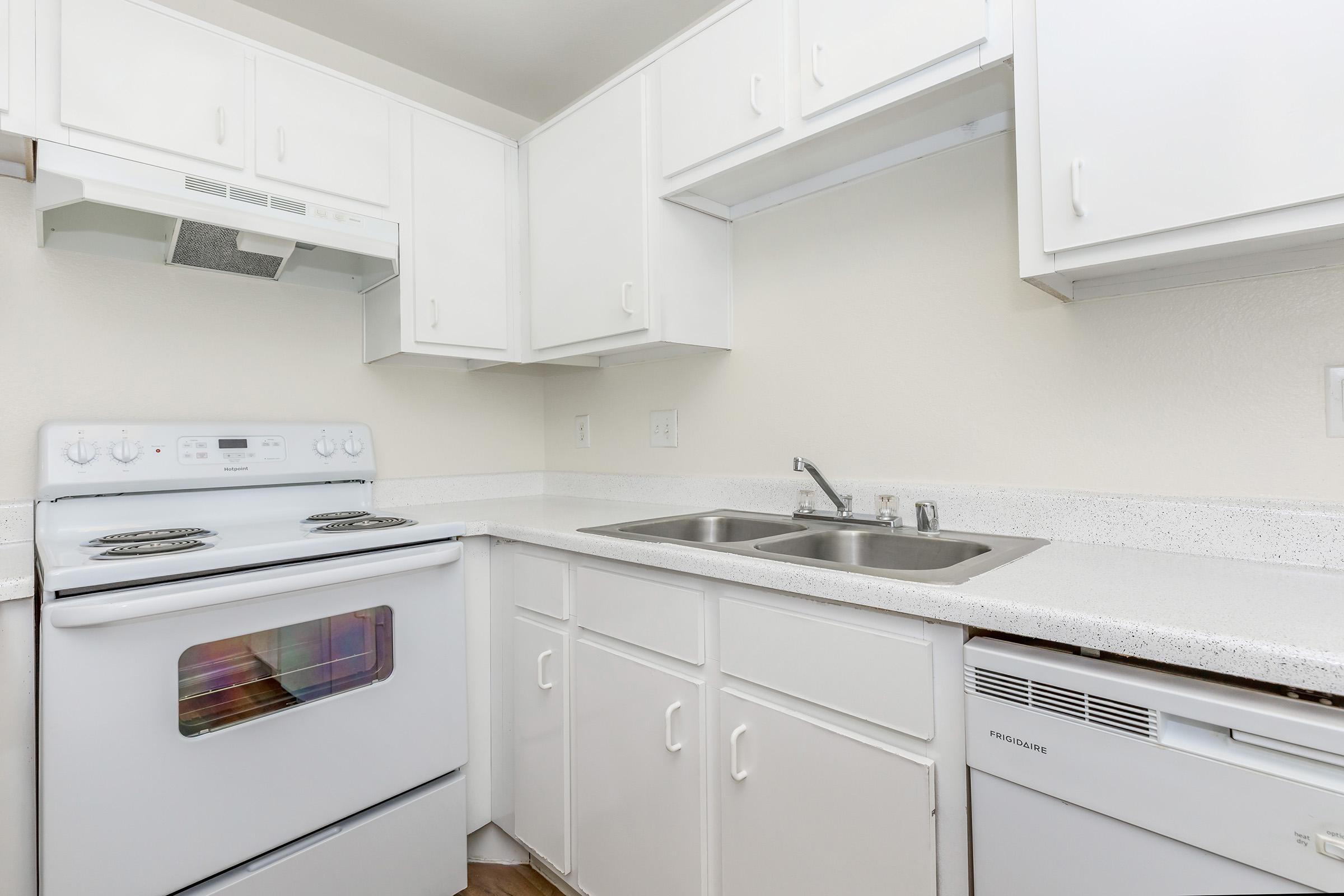 a kitchen with a stove and a refrigerator