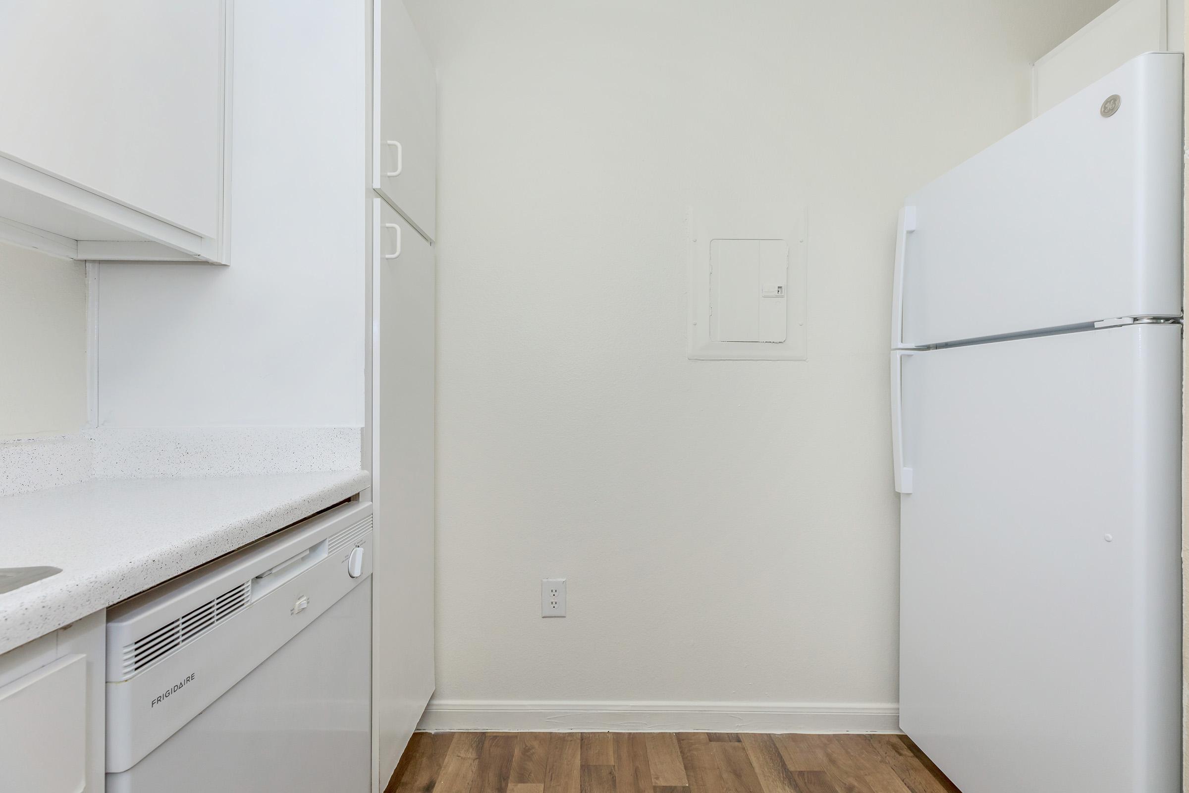 a kitchen with a stove and a refrigerator