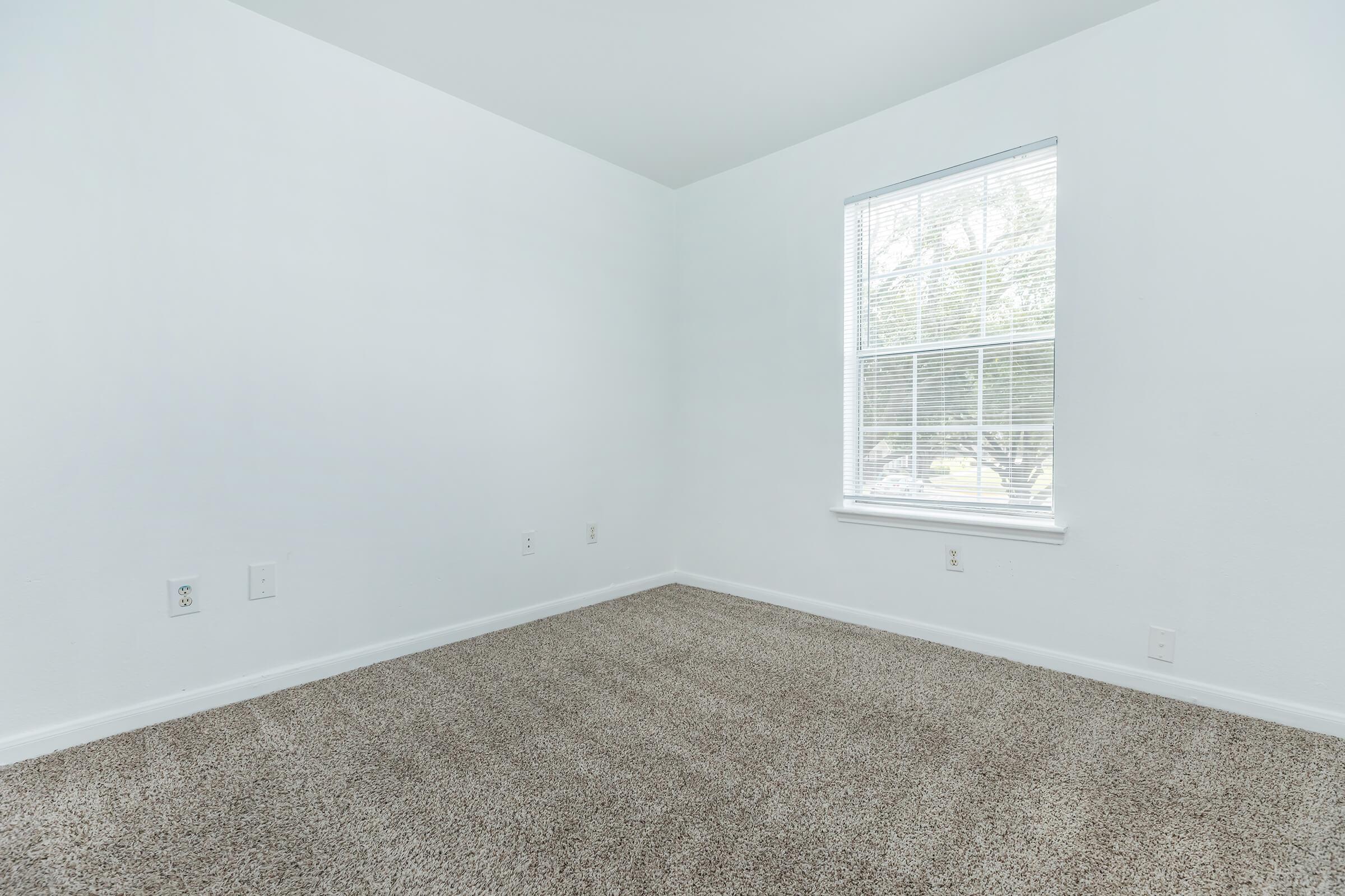 a bedroom with a large window