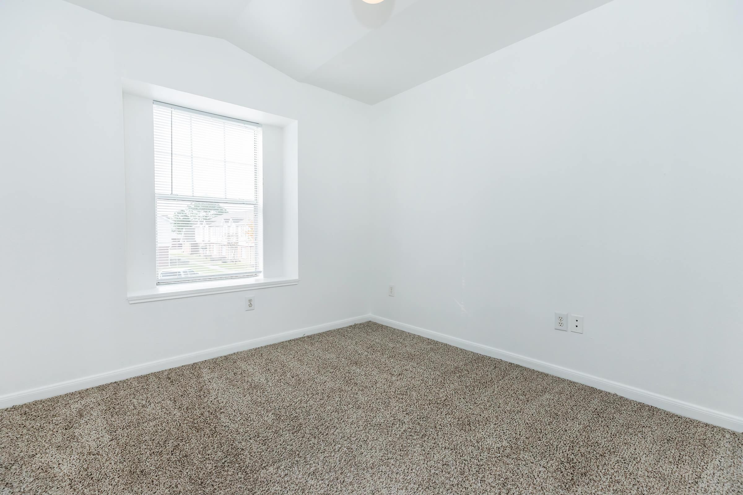 a bedroom with a large window