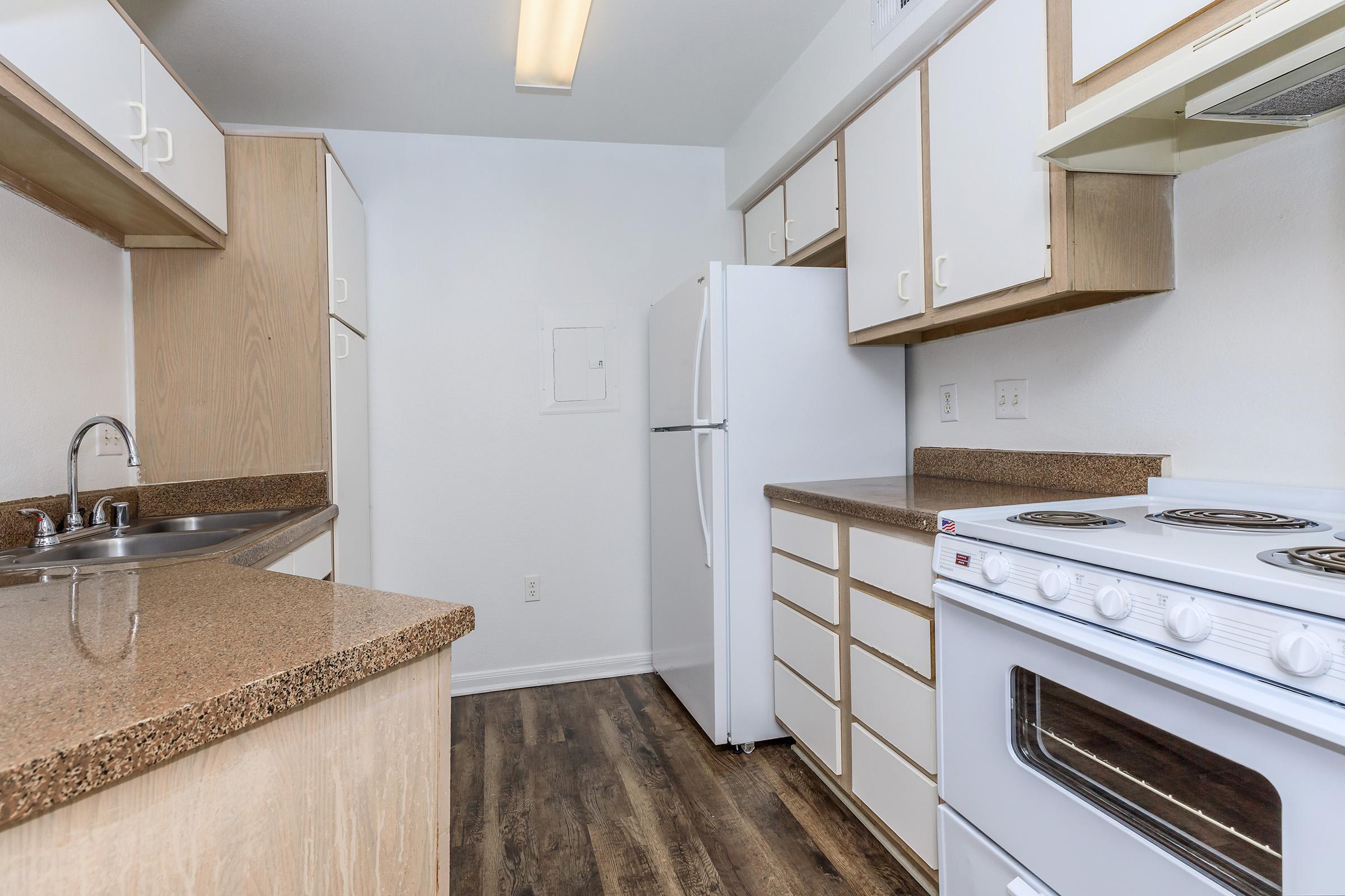 a kitchen with a sink and a mirror