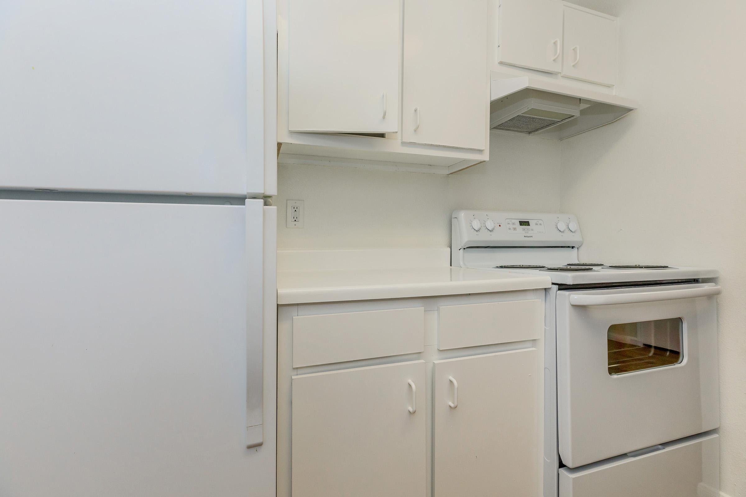 a kitchen with a stove top oven sitting inside of a refrigerator