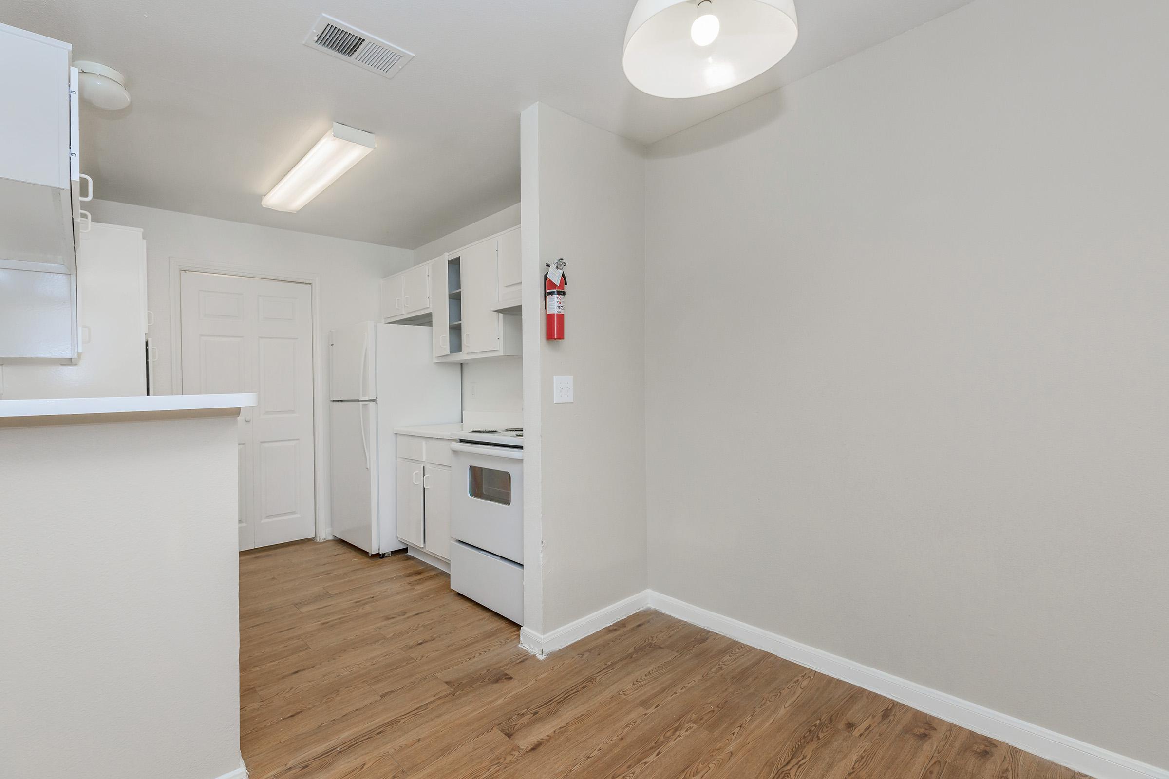 a kitchen with a stove and a refrigerator