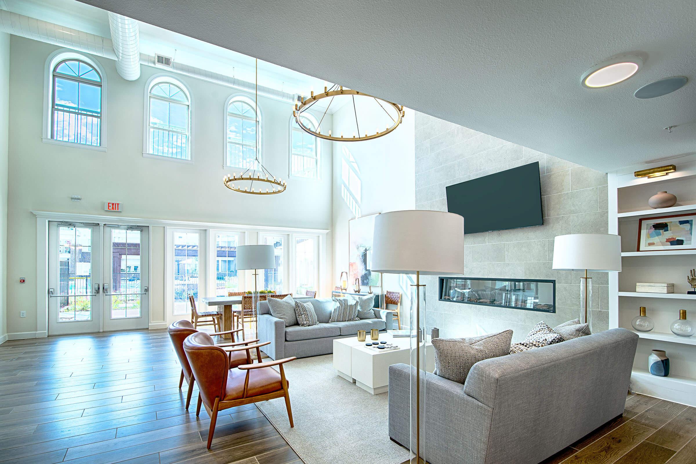a living room filled with furniture and a large window