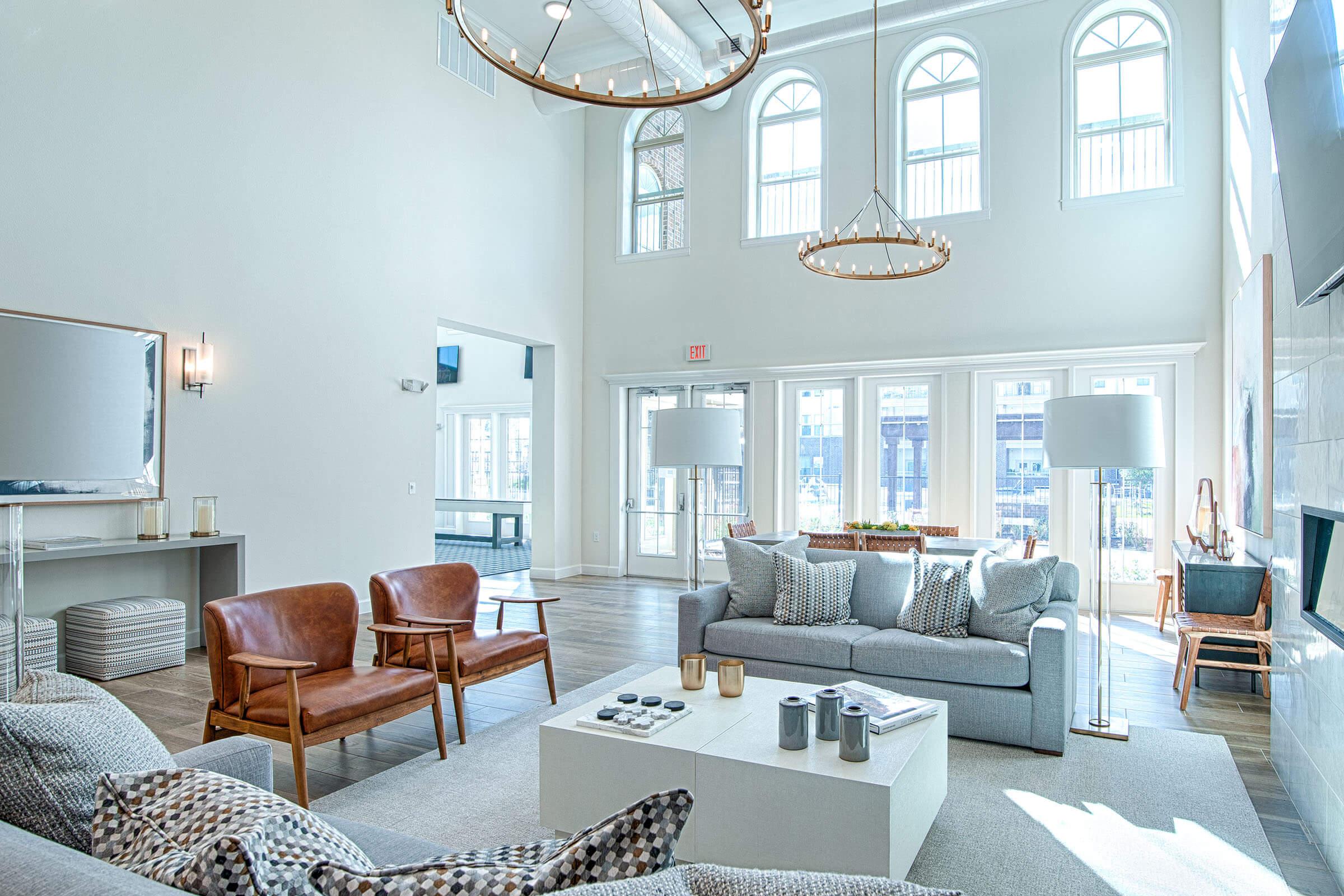 a living room filled with furniture and a large window