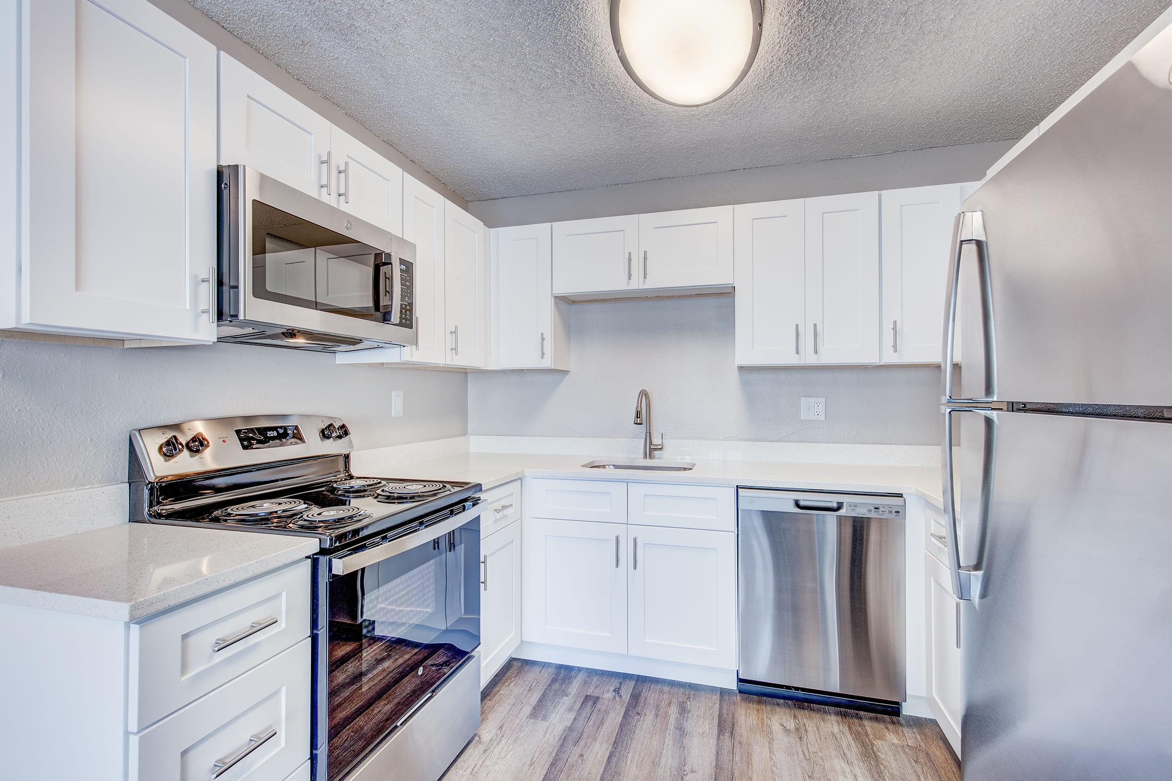 a kitchen with a stove sink and refrigerator