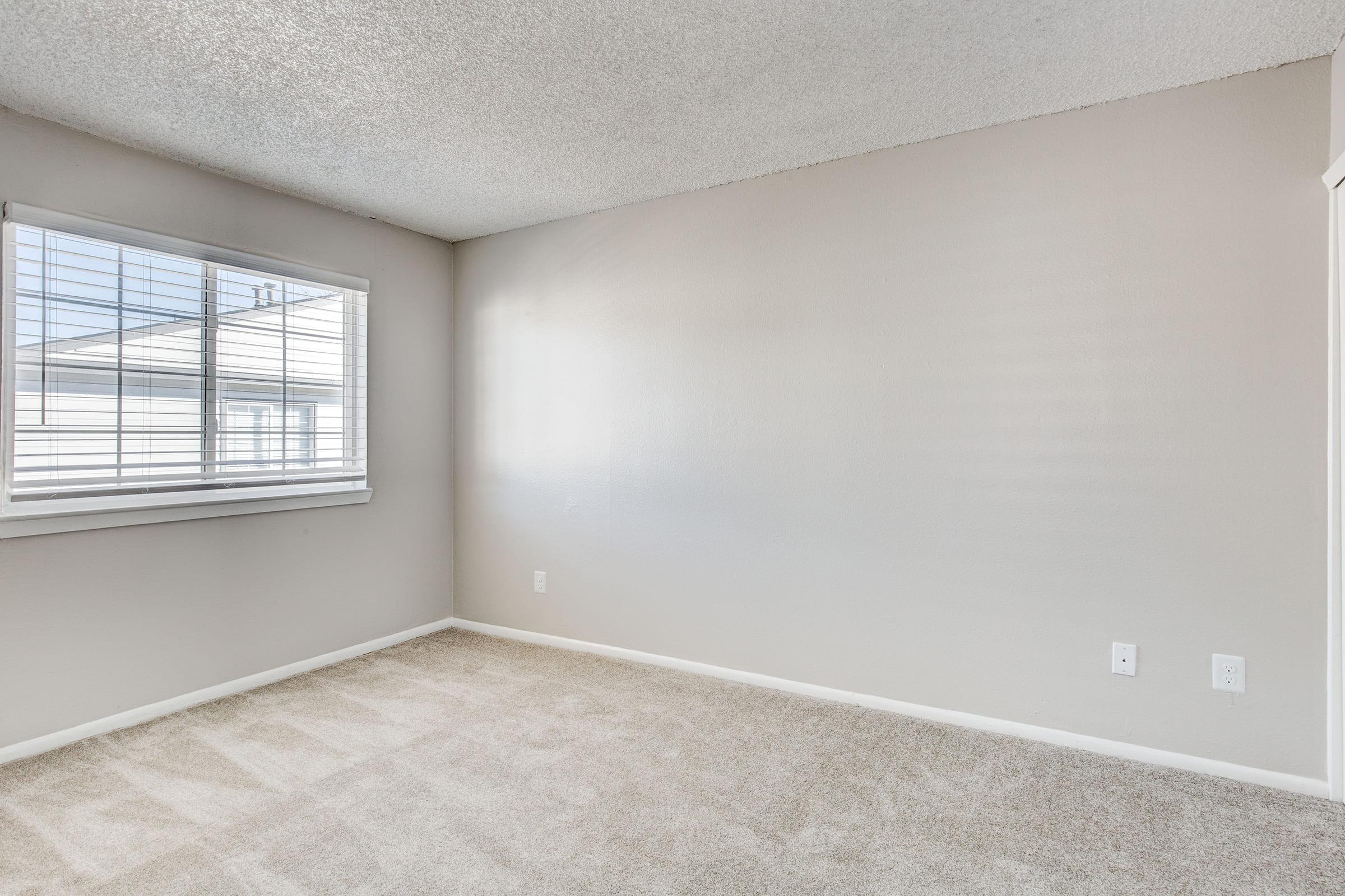 a bedroom with a large window