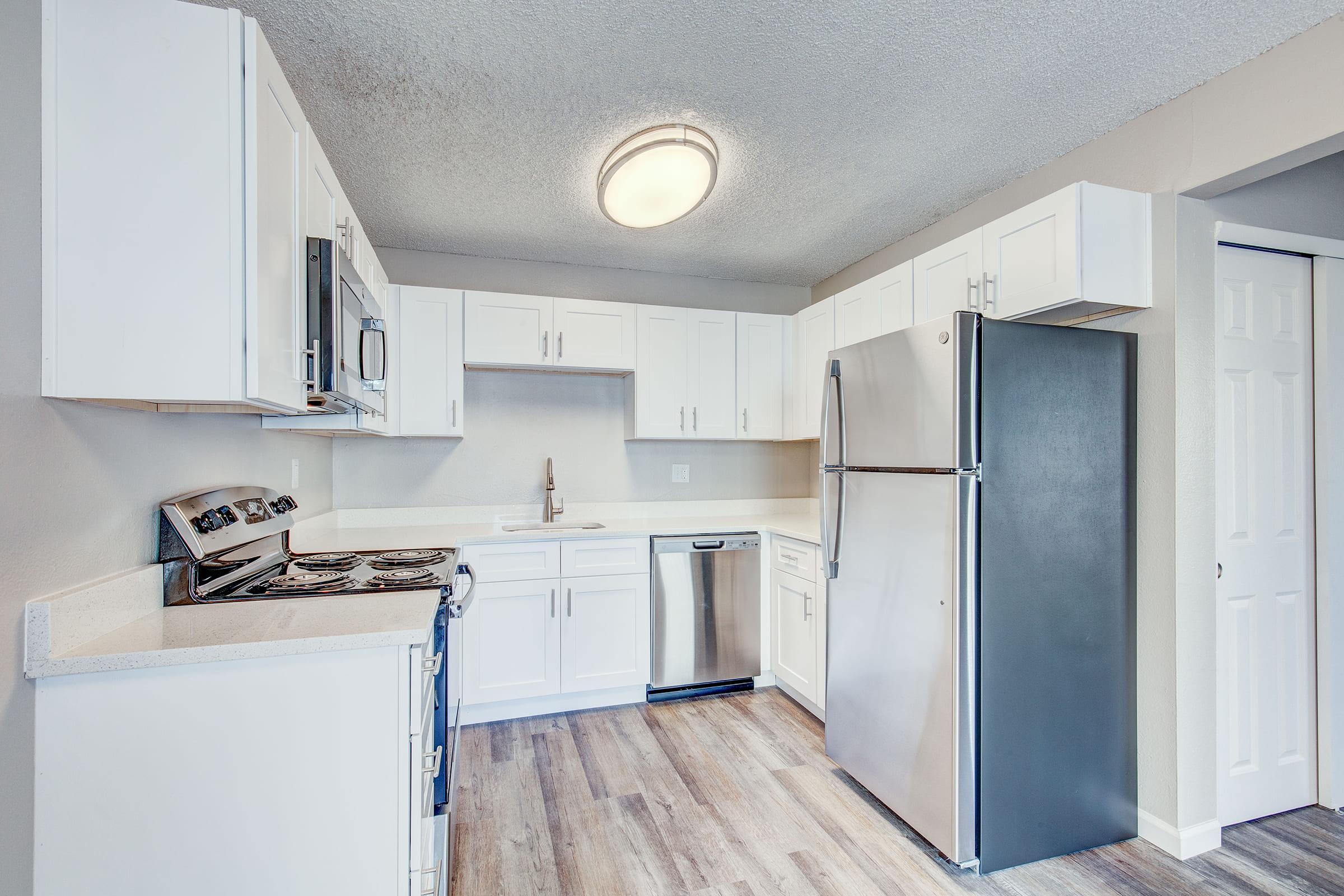 a kitchen with a stove and a refrigerator