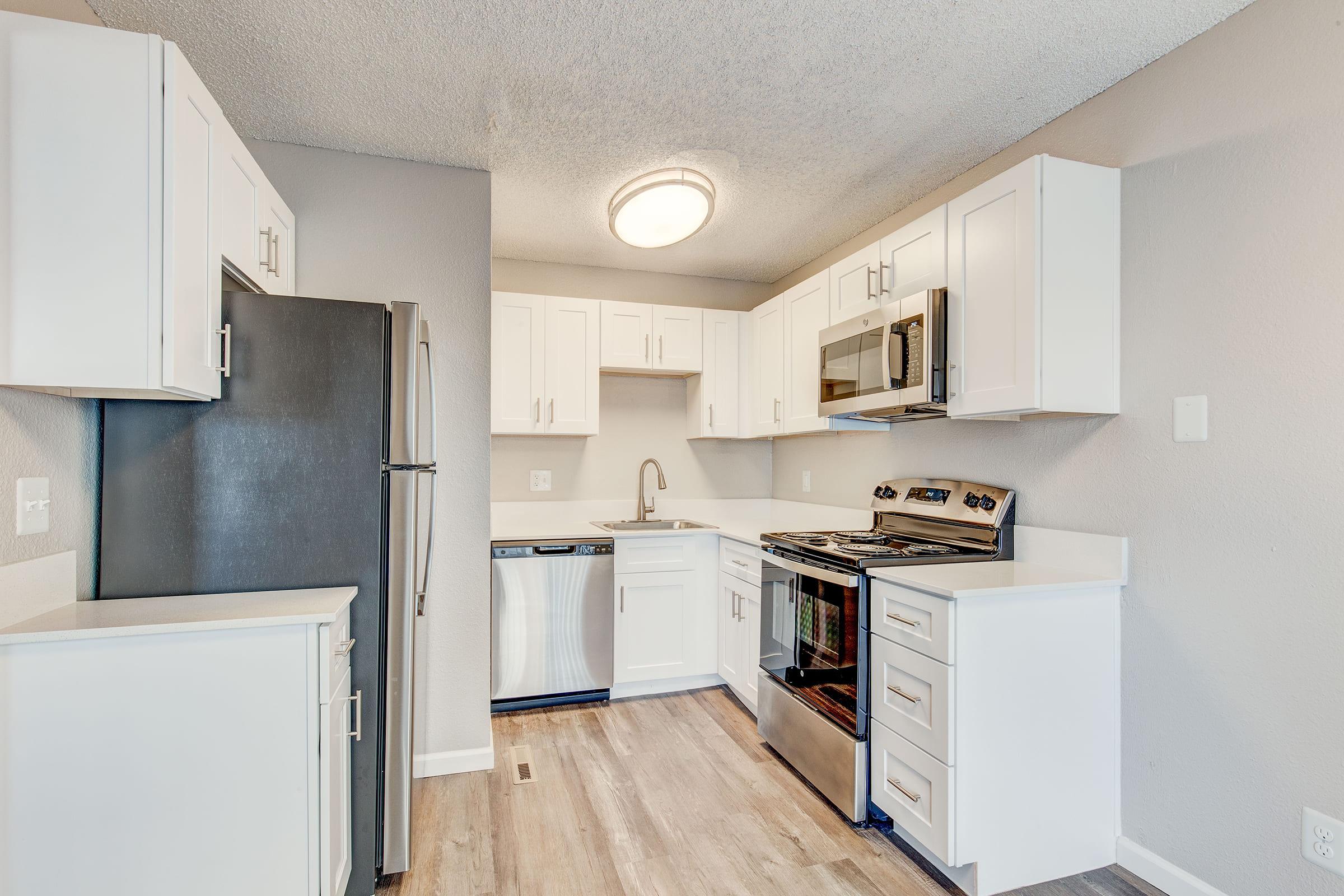 a kitchen with a stove and a refrigerator