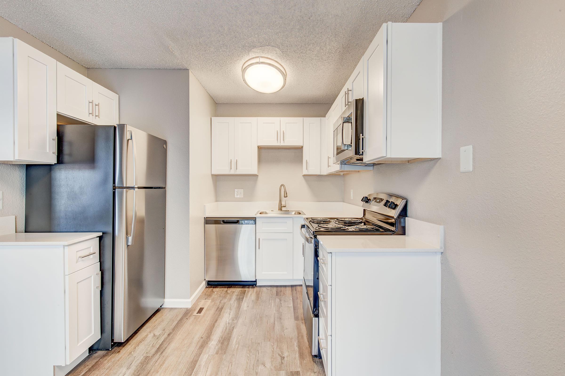 a kitchen with a stove and a refrigerator