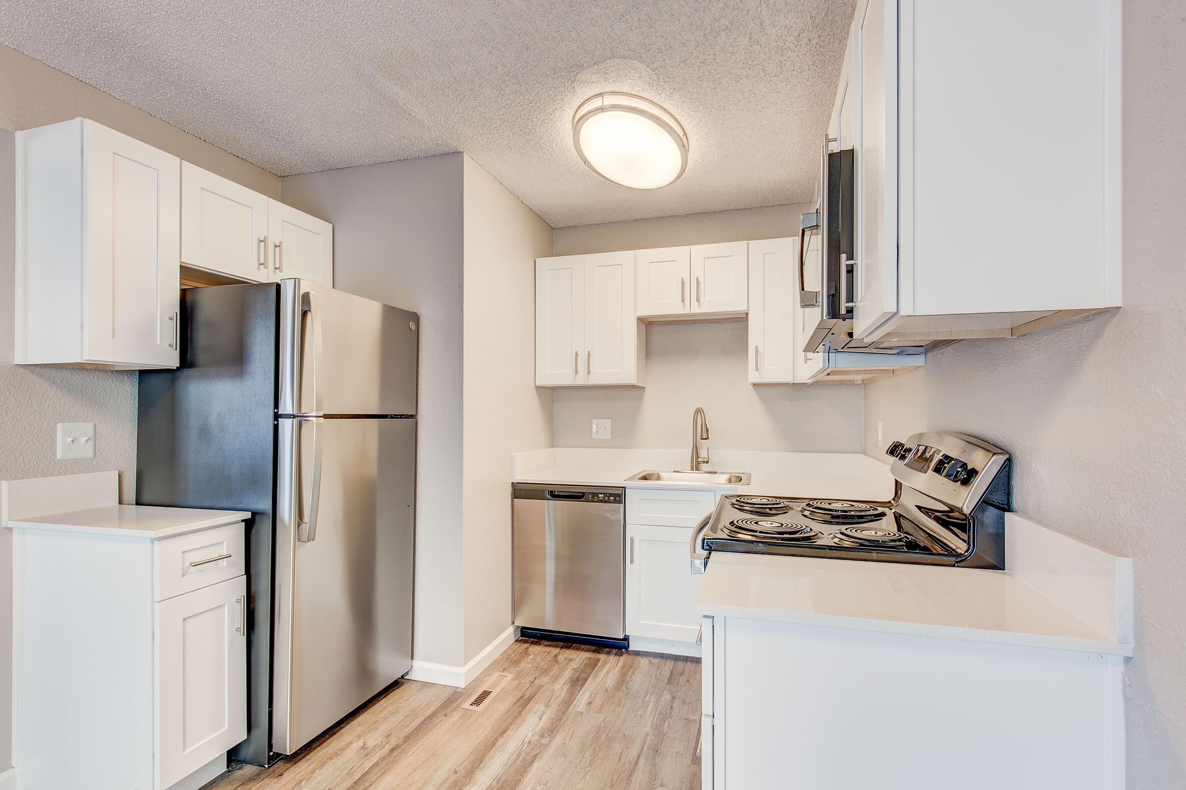 a kitchen with a stove and a refrigerator