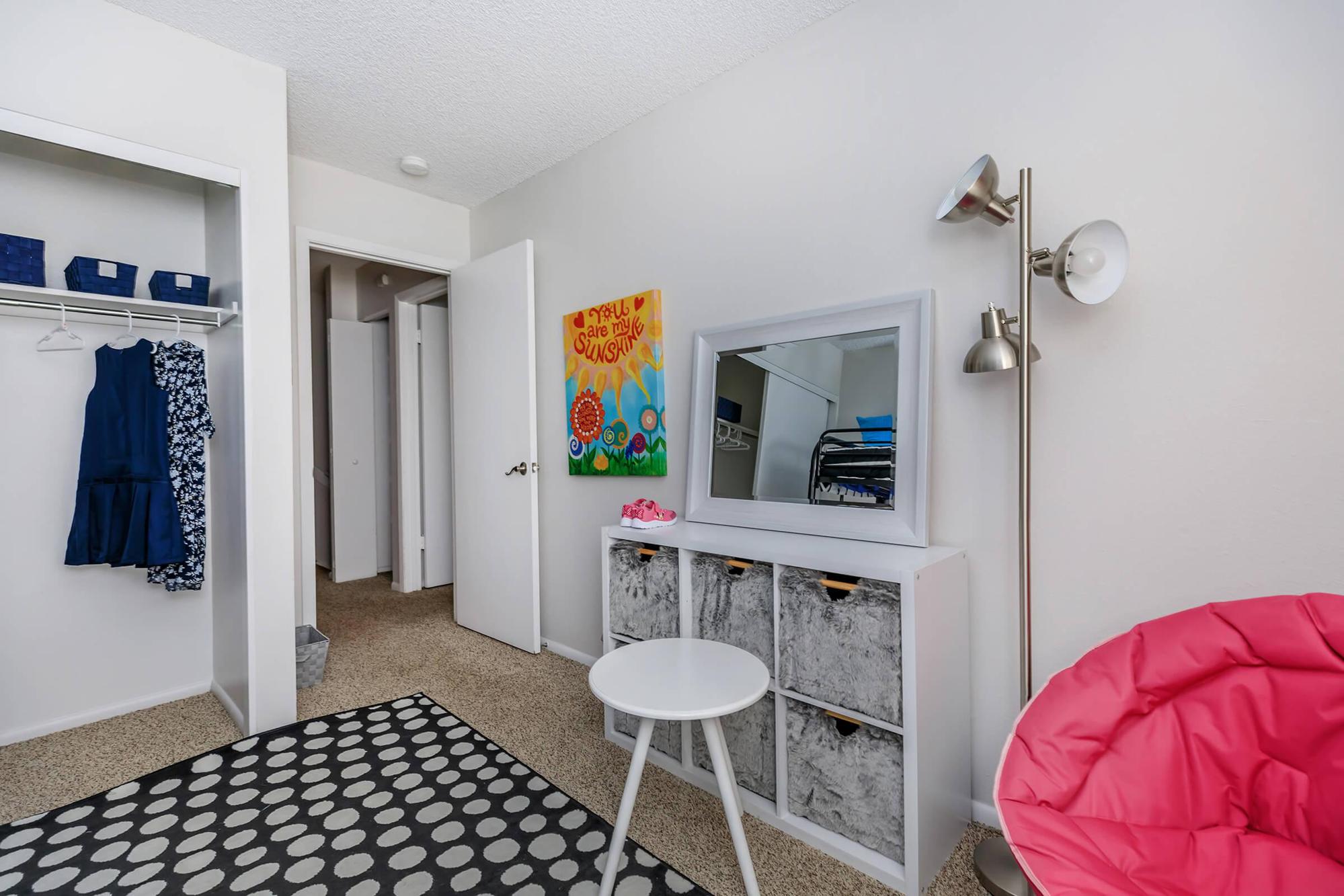 a bedroom with a bed and desk in a room