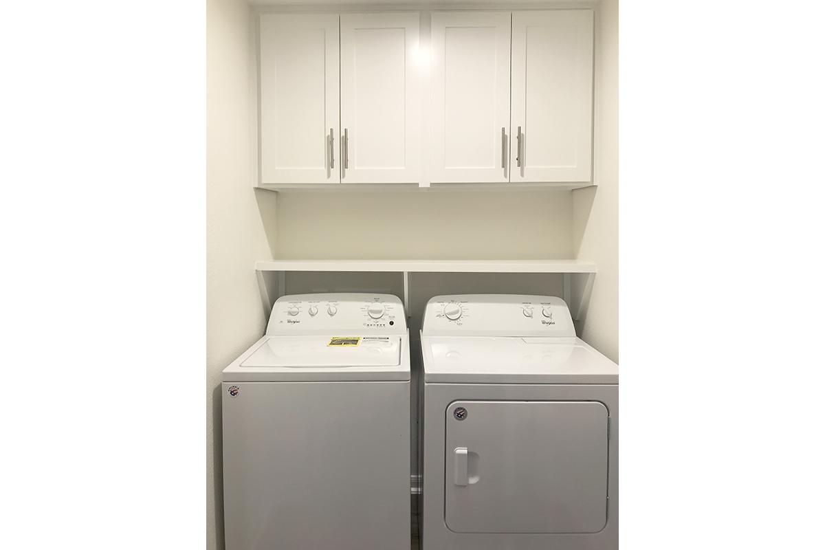 a white microwave oven sitting on top of a refrigerator