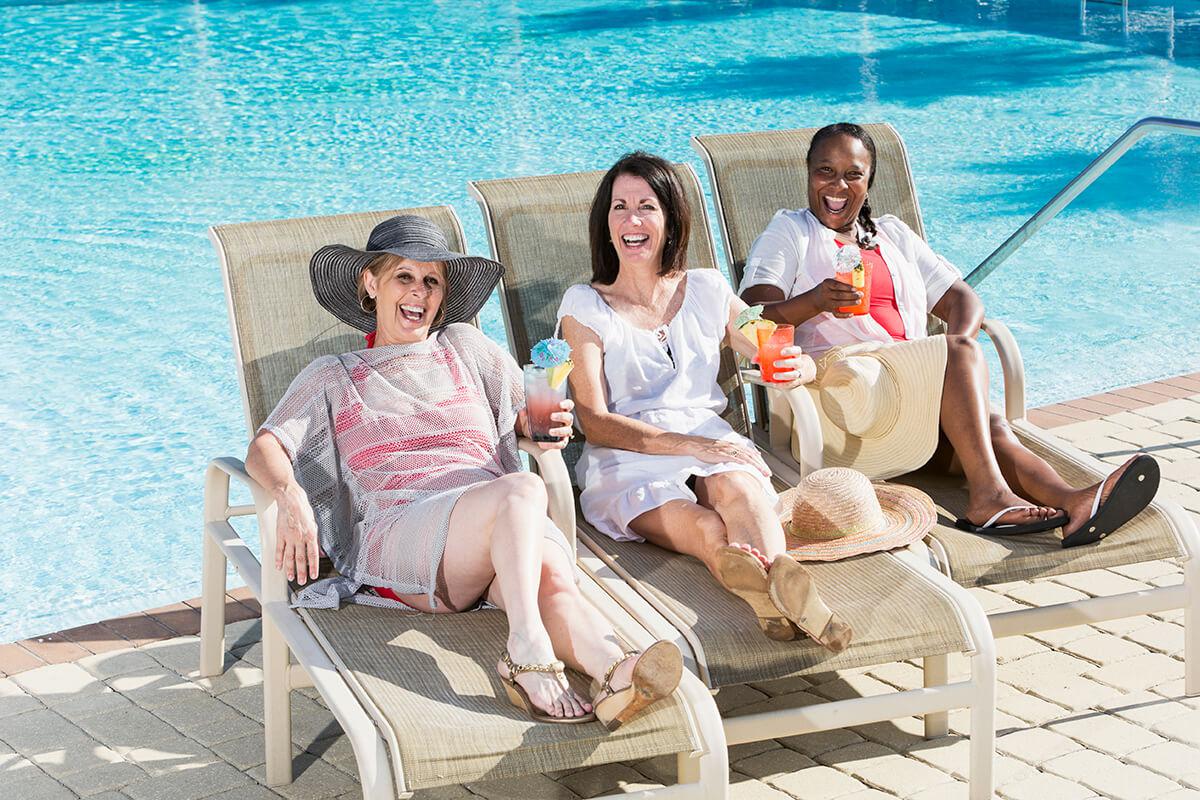 Women having drinks by pool.jpg