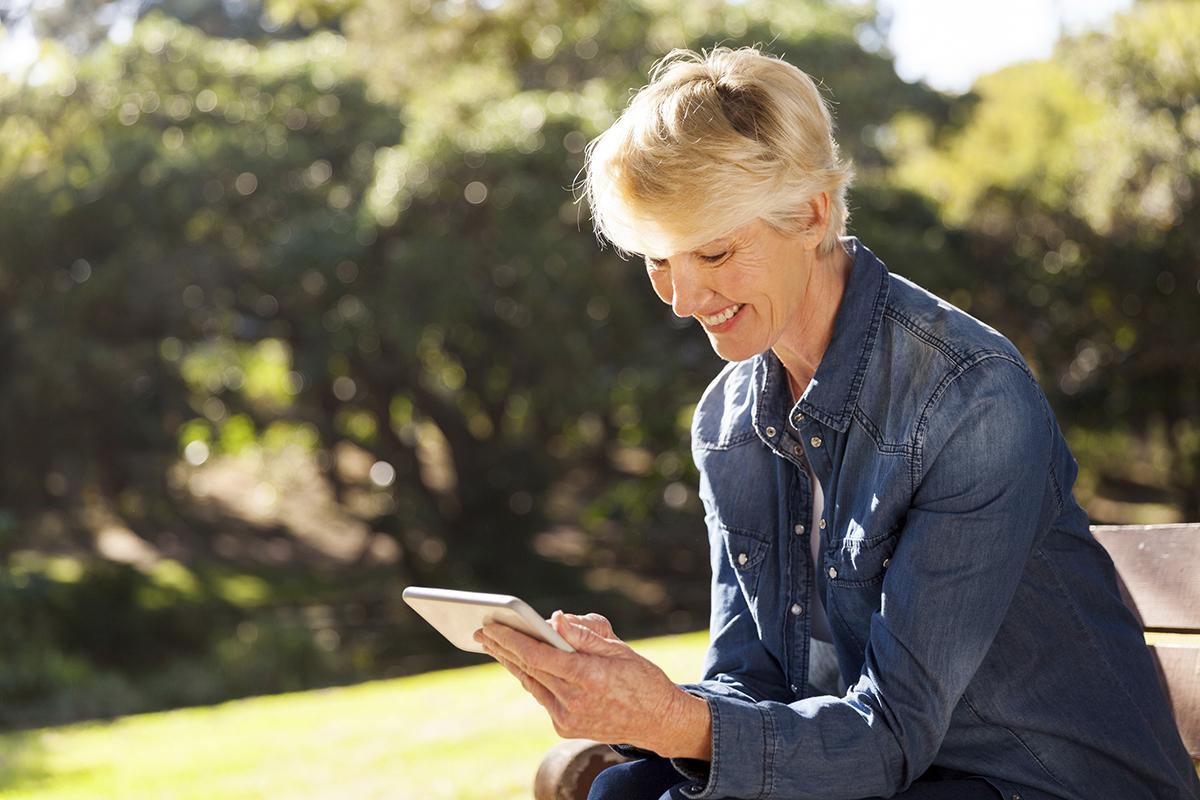 senior blond woman texting.jpg