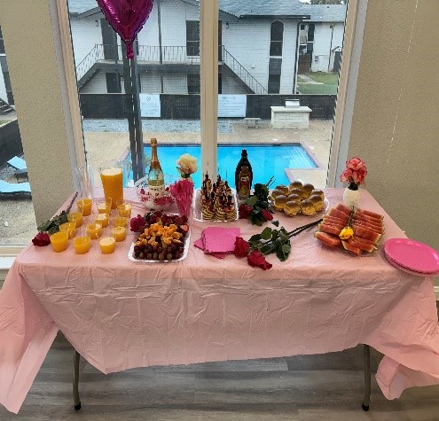 a person sitting at a table with a birthday cake