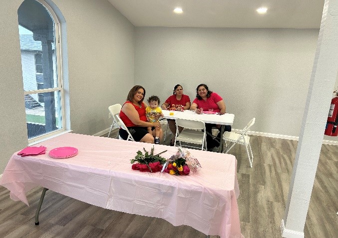 a person sitting at a table with a cake on a bed