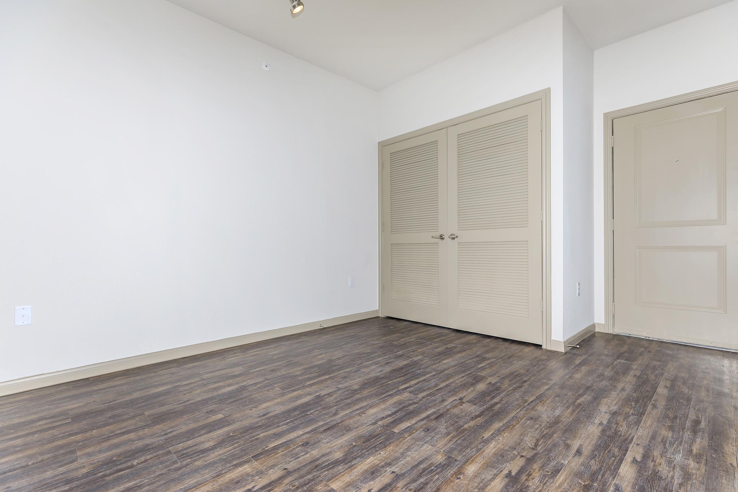 a bedroom with a building in the background