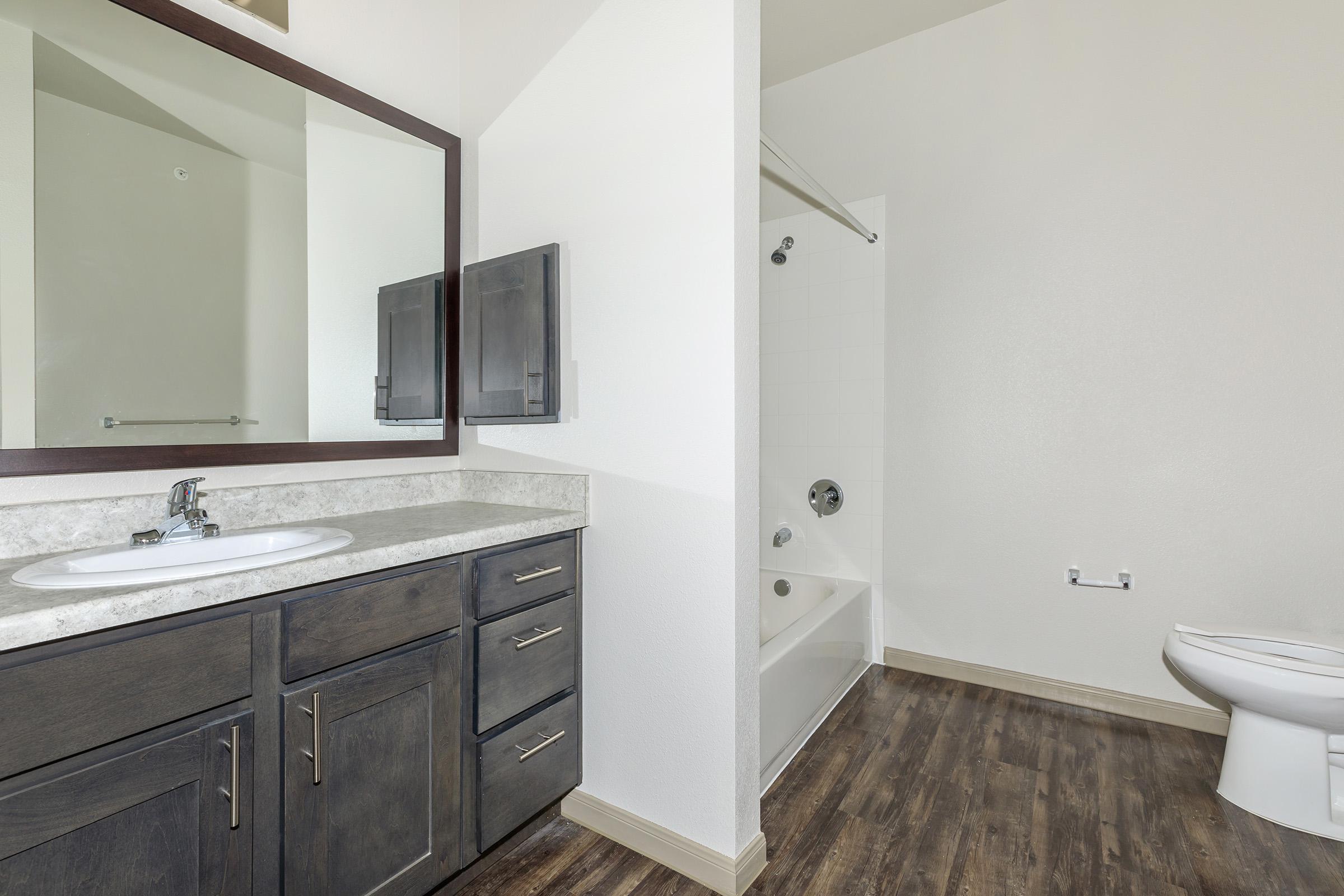 a kitchen with a sink and a mirror