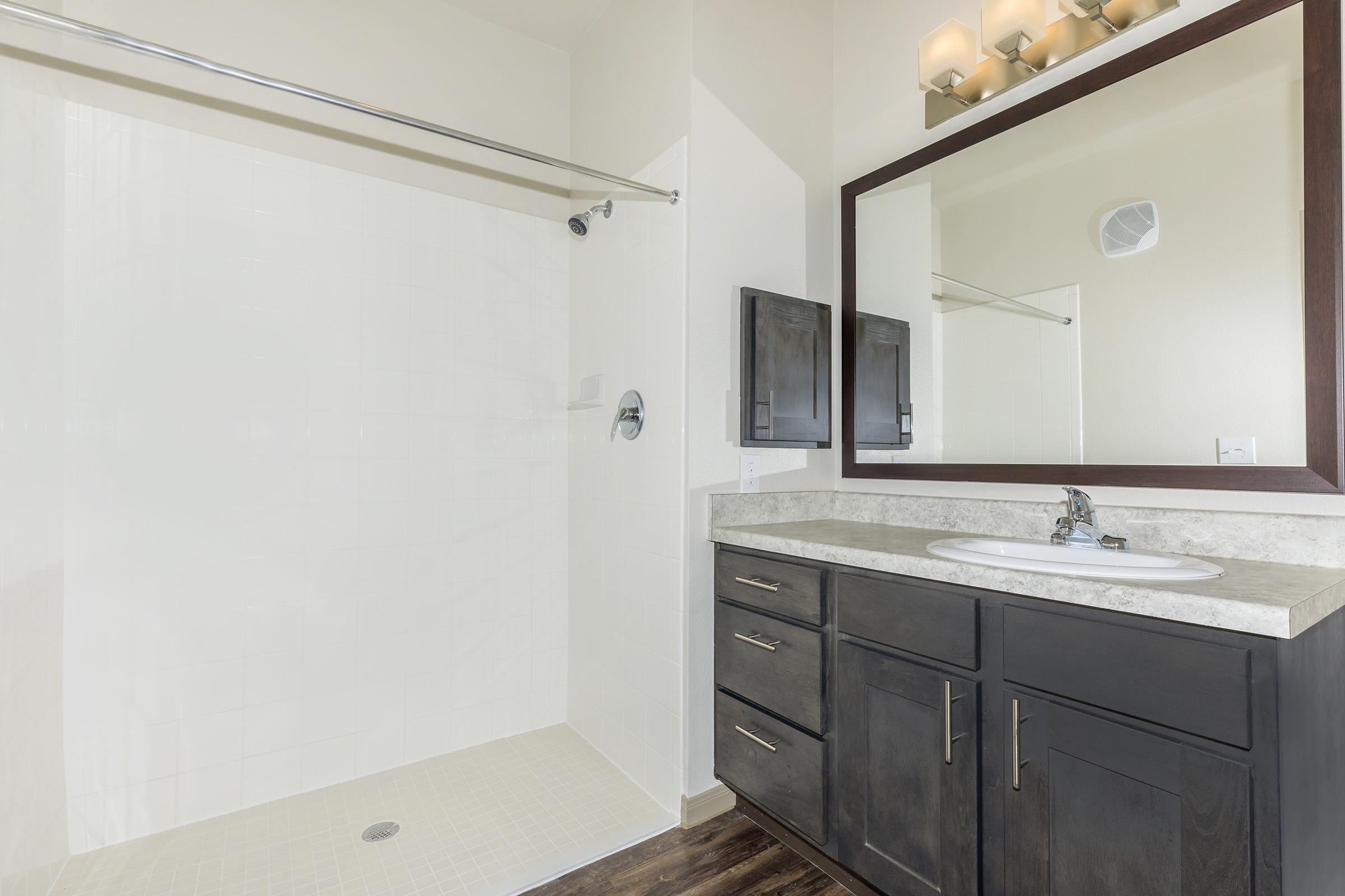 a kitchen with a sink and a mirror