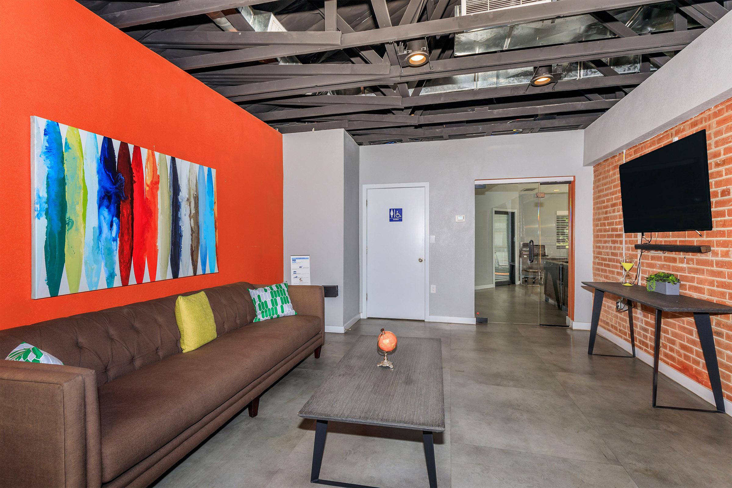 Modern lounge with sofa in The Wexler clubhouse.