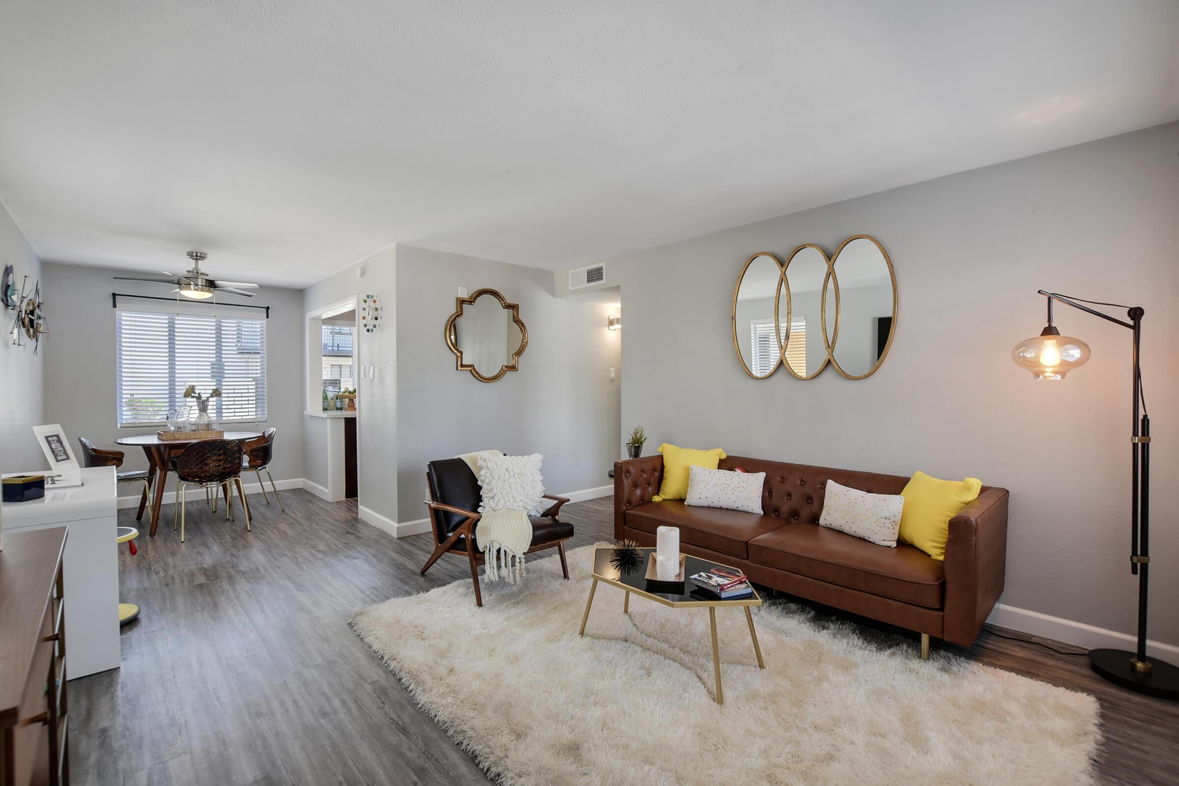 a living room filled with furniture and a wood floor