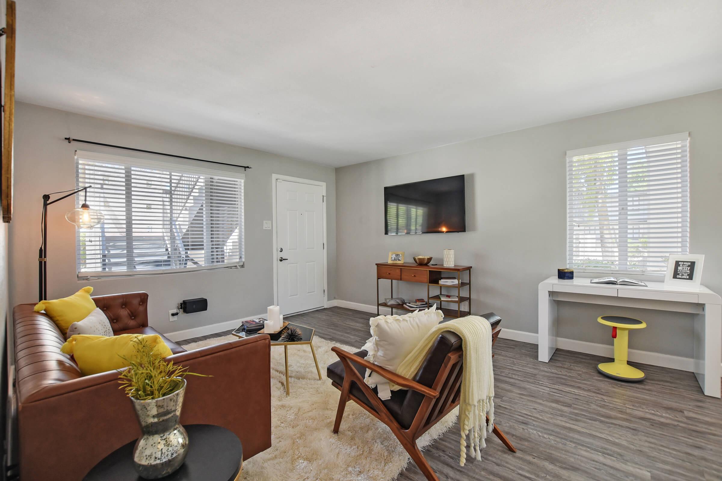 a living room filled with furniture and a large window