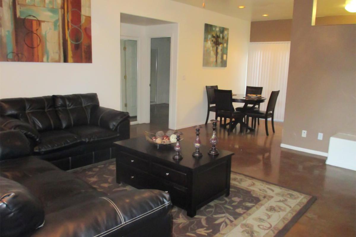 a living room filled with furniture and a table