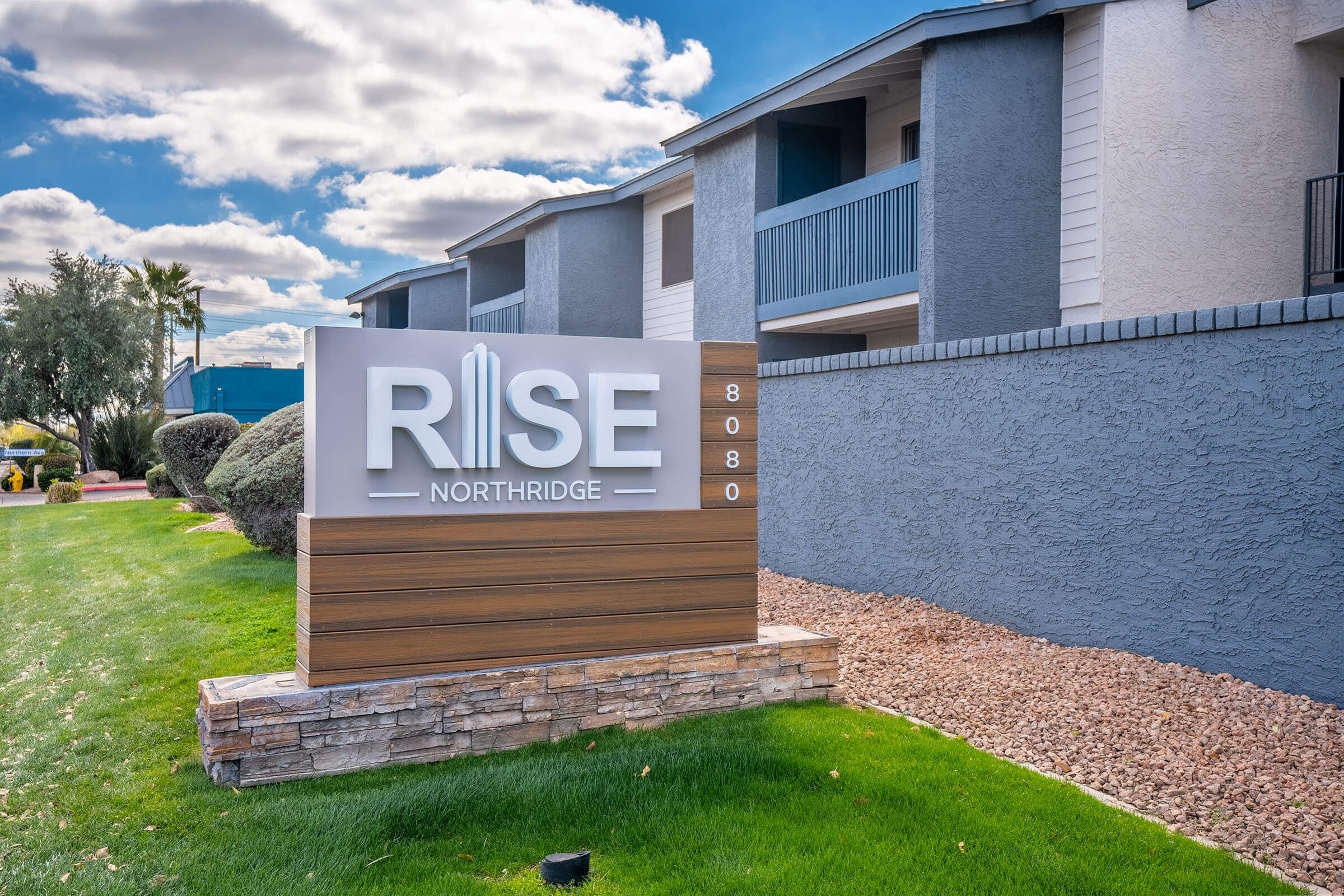 Rise North Ridge entrance signage with apartments behind it.