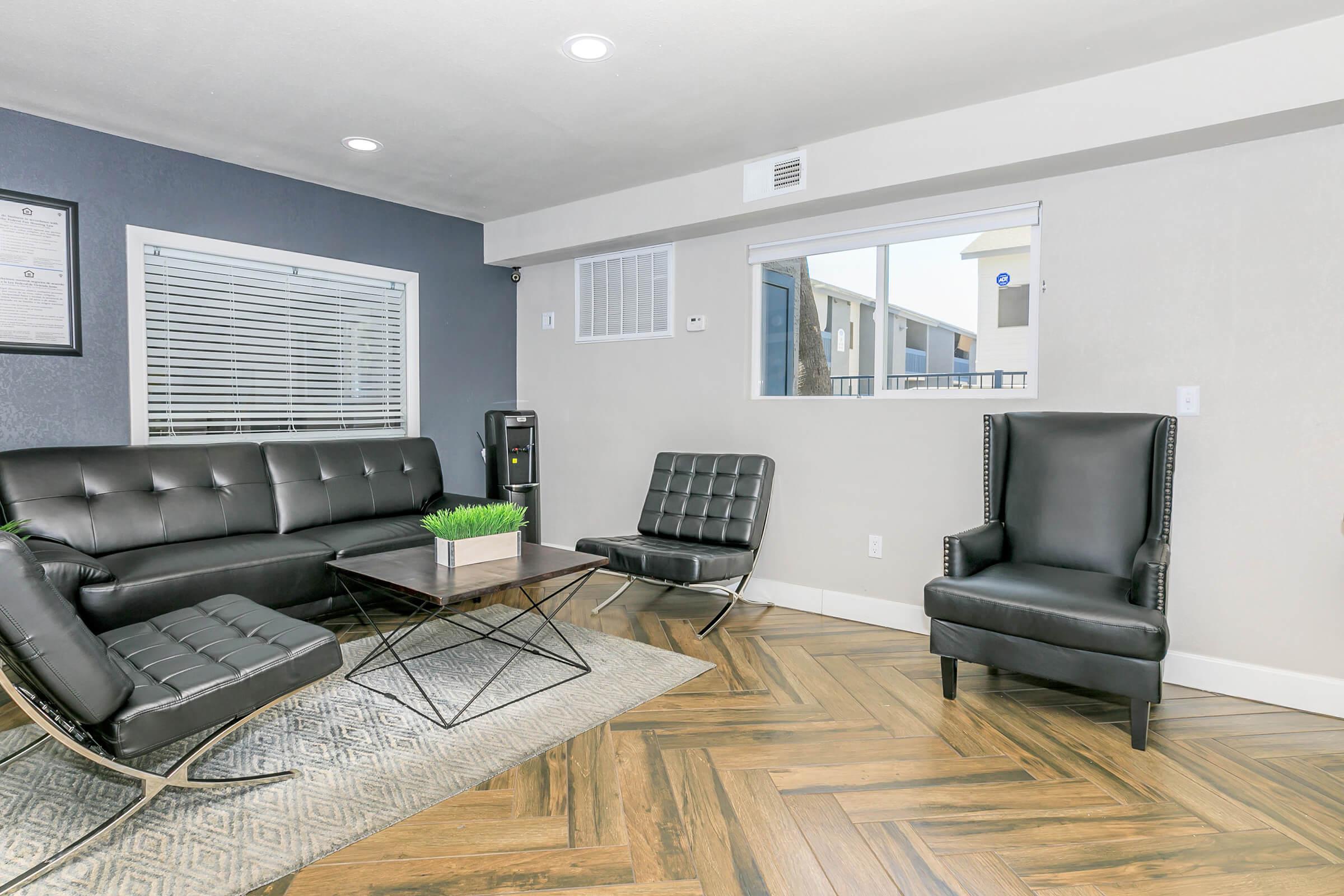 The leasing office at Rise North Ridge with black lounge chairs.