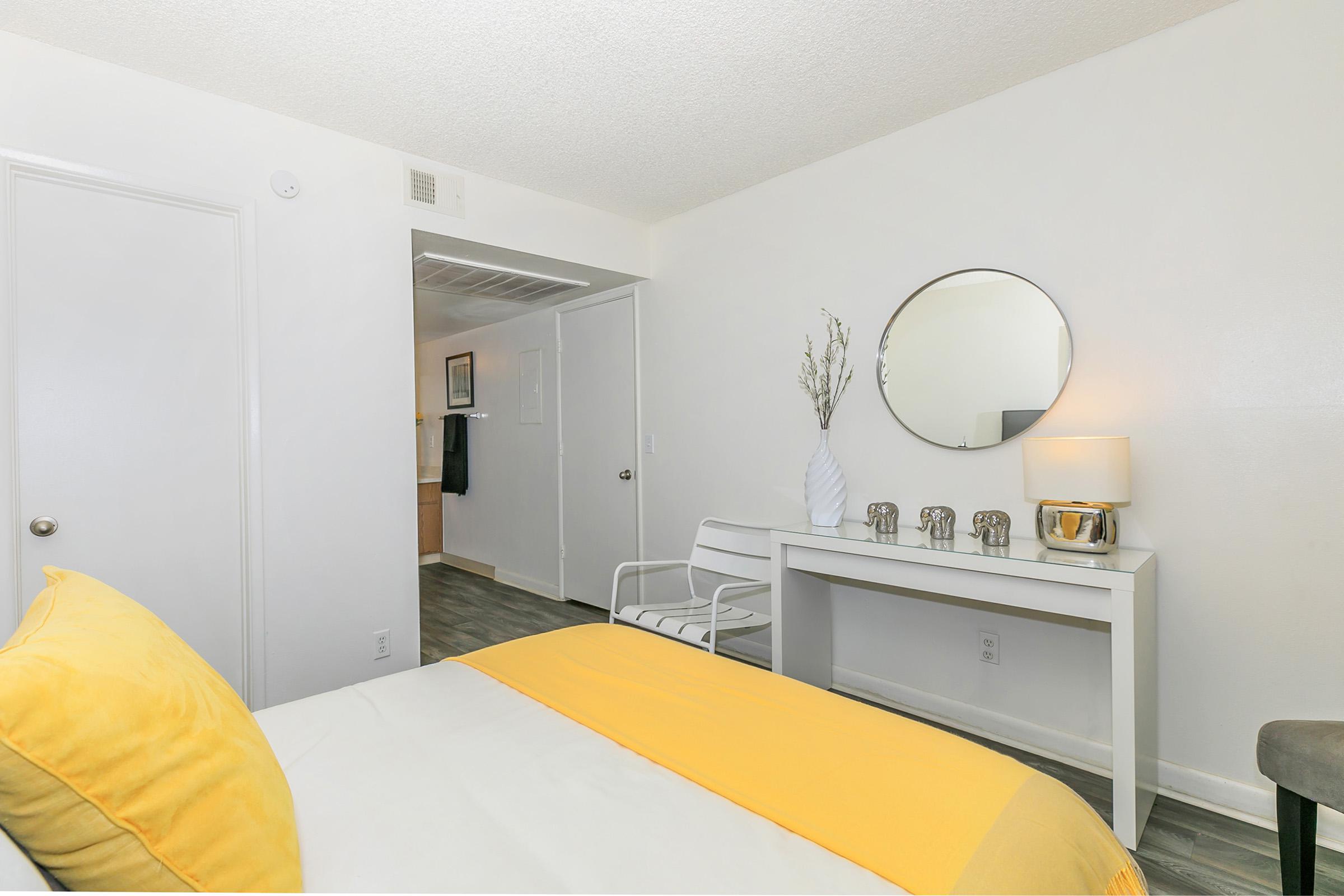 A queen bed in a bedroom with an en-suite bathroom at Rise North Ridge.