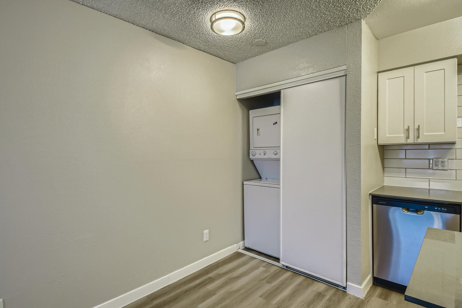 The dining area with a washer and dryer in a closet at Rise North Ridge.