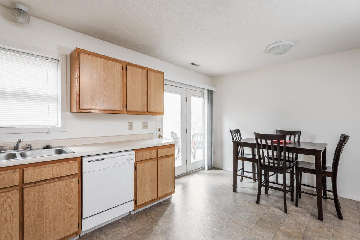 a kitchen with wooden cabinets