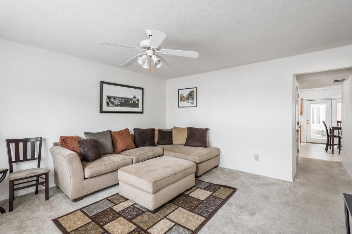 a living room filled with furniture and a wood floor