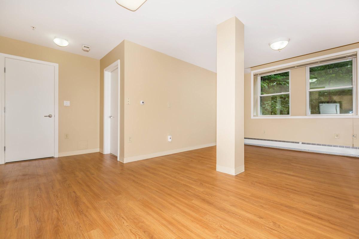 a large empty room with a wood floor