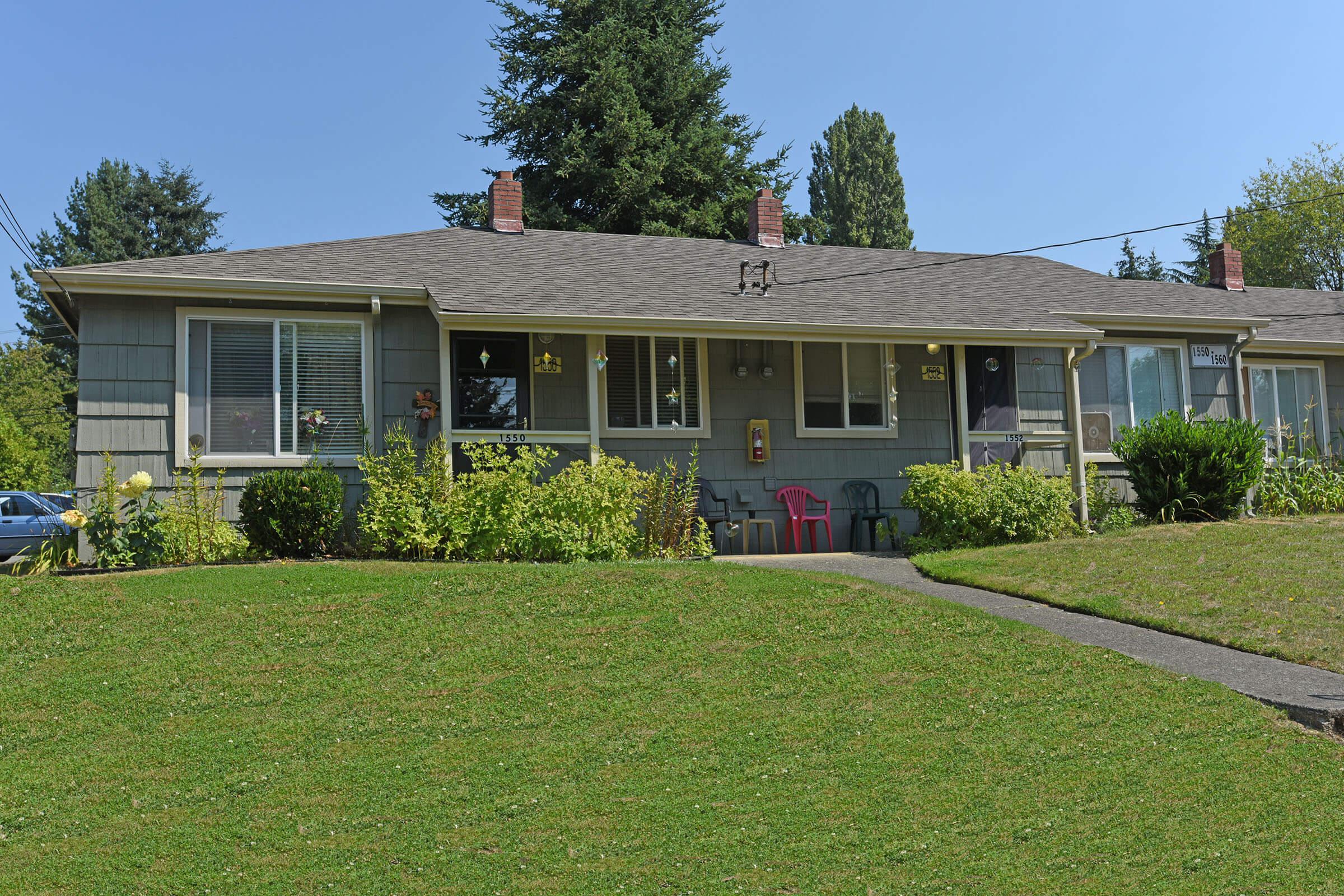 a large lawn in front of a house with Mission House in the background